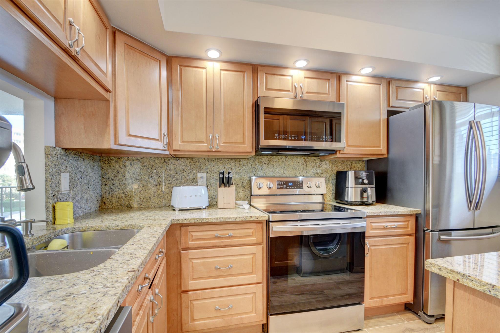 Beautifully renovated 2 bedroom, 2 bathroom with wrap around balcony offering beautiful Intracoastal views in Palm Beach Harbour Club! Stunning ceramic wood style floors, custom kitchen cabinets & drawers, automatic shades, and built-in wall units in bedrooms. Great furniture included! New impact windows! Building amenities include large pool on the Intracoastal, jacuzzi, Day dock, and deeded beach access. Well maintained property with lush tropical landscaping!