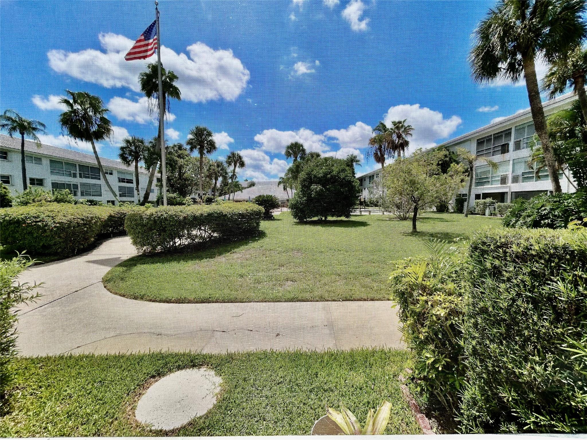 Lovely first floor condo in Desirable Lighthouse Point.    Updated neutral tile floors throughout, bathrooms have been remodeled beautifully.   Screened patio faces south with lovely lawn, garden and pool area views!  Master bedroom has a walk in closet and a full size wall closet which is perfect for lots of clothes or storage.  There is an additional storage bin as well.      This is a very active 55+ community with no leasing first two years then 2 times per year for no less then 1 month and no longer then 10 months.   There is a land lease on the Rec  center of $17 per month which is included in monthly maintenance.   Fabulous Lighthouse point location, close to shopping, restaurants and worship.  Seller will give a $7,000 credit for kitchen.