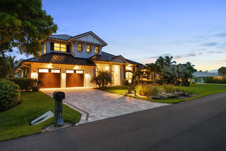 Stunning 2022 custom-built waterfront estate with 100' of frontage in Hobe Sound, just minutes from Jupiter Island. Designed by Kelly & Kelly and built on 45 concrete pilings, this Miami-Dade hurricane-compliant home offers PGT impact windows, lightning protection, roll-down lanai shutters, and a full-house Generac generator tied to a 1,000-gal propane tank. Interior finishes include a custom mahogany front door, rosewood kitchen cabinetry, Dolomite counters in the kitchen and laundry, California faucets, Shaw porcelain farm sink, and distressed hickory vanities with quartzite tops. Solid wood interior doors, African mahogany staircase with tile risers, cypress-lined outdoor ceilings, A/C garage, and A/C storage. Custom Almar Jackson pool/spa and Lynx outdoor kitchen. City water/sewer.