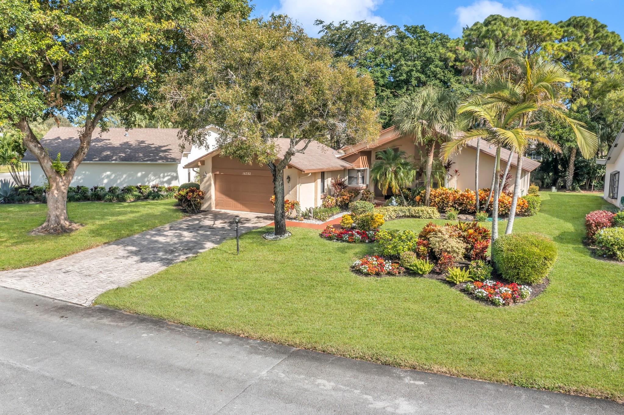 This home is known for its SPECTACULAR landscaping & BEST KEPT lawn in the community. This single Family home is 1,722 Sqft, with an open floorplan. Enjoy 2 over sized Bedrooms, 2 Bathrooms, spacious closets & an open floor plan. Neutral Tile throughout, Formal living & Dining Rooms. Open kitchen that opens to family room & formal dining room. Sliders out to Covered patio with incredible views. Oversized 2-car garage with ample amount of storage. NO ANNUAL DUES & NO INITIATION FEE. Great amenities include 18 holes of par-60 Golf on 145 acres, clubhouse, pool, Cafe/restaurant, Fitness Center, Tennis, pickleball, Clubs, Parties, 55+ Country Club. Convenient location close to restaurants, beaches, interstate, shopping & more. Basic cable & Internet included in HOA fee.