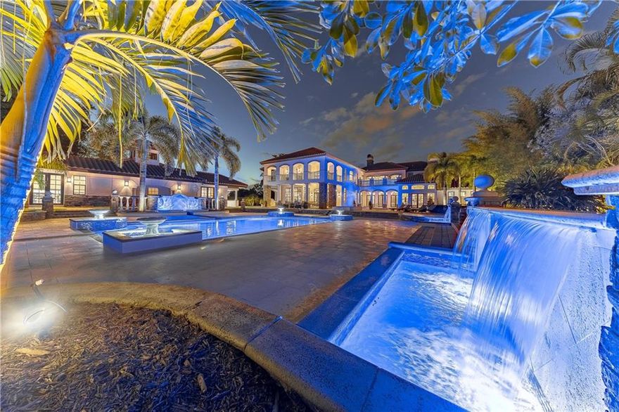 Stunning gated estate in Parkland! This 12,000 sf mansion comes loaded with updates & Smart Home features, including a theater, custom wine cellar, 2000 sf guest house, saltwater pool, elevator, gym, bar, outdoor kitchen, impact windows & much more. Double electric gates will lead you through the circular driveway surrounded by impeccably manicured gardens & into this 2-acre dream estate. Top-of-the-line appliances, high ceilings & electric window treatments. The Master bedroom & bathroom were recently redone with Chicago brick ceilings. Outdoor spa out of master bathroom shower, enclosed for privacy. Oversized terrace & pool with jacuzzi, perfect for entertaining guests. Excellent location in "A" rated school zone, near major roadways & equestrian ranches.