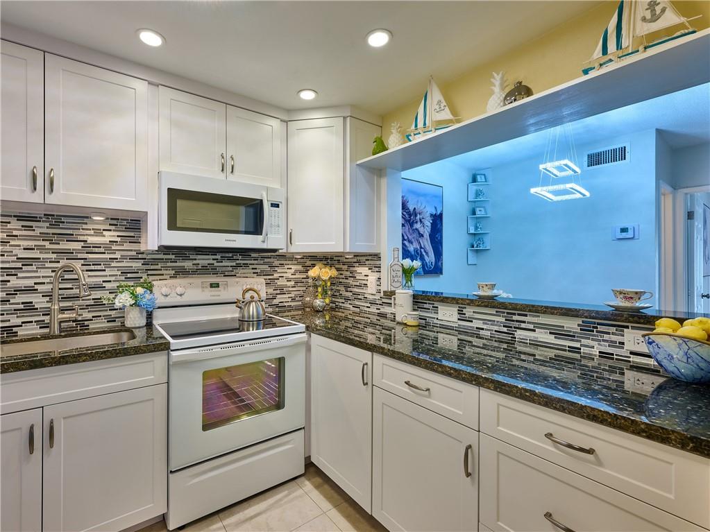 WELCOME TO THIS BEAUTIFULLY RENOVATED FULLY FURNISHED 1 BED & 1,5 BATH UNIT FEATURES IMPACT WINDOWS AND DOOR. WHITE KITCHEN CABINETS, GRANITE COUNTERTOPS, TILE BACKSPLASH, UNDERMOUNT LIGHTS AND RECESSED LIGHTS. THE KITCHEN OPENS TO THE SPACIOUS LIVING AND DINING ROOM. UPDATED BATHROOMS. FRESHLY PAINTED. LAMINATE FLOORING. NEWER A/C UNIT AND WATER HEATER. THE SPACIOUS BEDROOM WITH SLIDING DOORS TO THE BIG SCREENED BALCONY OVERLOOKS CLUBHOUSE AND BEAUTIFULLY LANDSCAPED GARDEN. PLENTY OF CLOSETS. EXTRA STORAGE, LAUNDRY ROOM AND ELEVATOR ON THE SAME FLOOR. ASSIGNED PARKING SPACE N63. THIS 55+PLUS COMMUNITY HAS CLUBHOUSE, HEATED POOL, BBQ GRILLS, BOCCE BALL AND MUCH MORE . NO LEASING. NO PETS. CLOSE TO SHOPPINGS, BANKS, RESTAUTANTS, LIBRARY, BEACH. PERFECT RESIDENCE OR GATEWAY. MOVE IN!