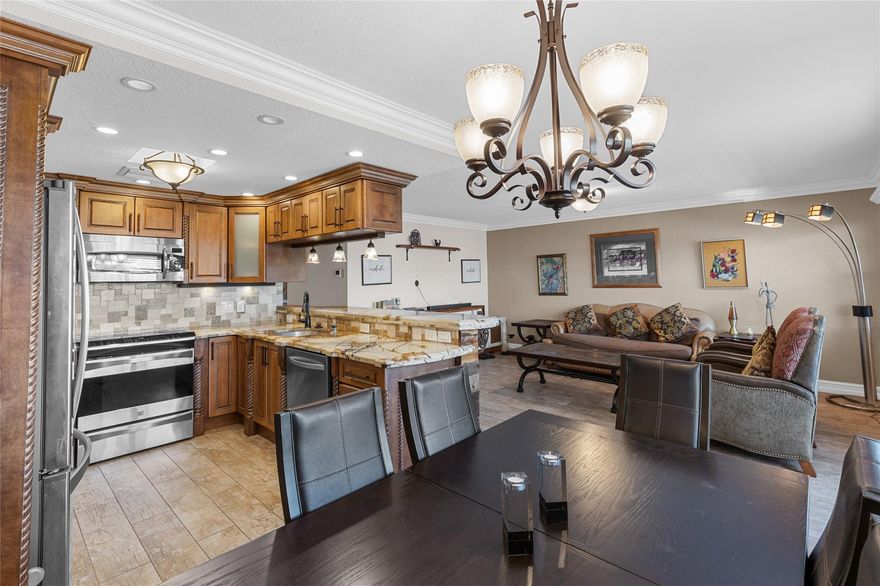 Unique opportunity to own this stunning home! Too many features to name them all, this one must be seen to be truly appreciated! Featuring high impact front windows and door, kitchen boasts all custom cabinetry, granite counters with extended island, shiplap accents, s/s appliances, recessed and pendant lighting. The bathrooms were designed for royalty with a spa-like walk-in shower accented by natural pebble stones or relax and unwind in the luxurious jacuzzi tub. All new ceramic wood plank and bamboo flooring. Additional features include a tankless water heater & newer electrical panel! Newly remodeled Olympic size pool located diagonally from the building. Century village has resort style amenities including a clubhouse, theater, pickleball, tennis, restaurant, courtesy shuttle & more!