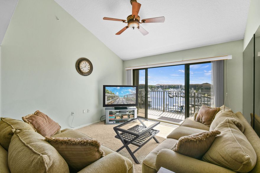 Enjoy this Bluffs Marina penthouse offering expansive marina views, where elegance meets comfort. This beautifully designed residence features soaring vaulted ceilings in the main living and dining areas as well as both bedrooms, creating an open and airy ambiance that sets it apart from lower-floor units. A spacious bonus room provides versatile options for an third bedroom, office, storage, or hobby space. Residents can enjoy four pool areas with covered pavilions and breathtaking marina and lake views—perfect for relaxation. Stay active with tennis and pickleball courts available for day or night play. The lush professionally maintained landscaping and winding sidewalks create an ideal setting for leisurely walks or safe biking, all complemented by refreshing tropical breezes.
