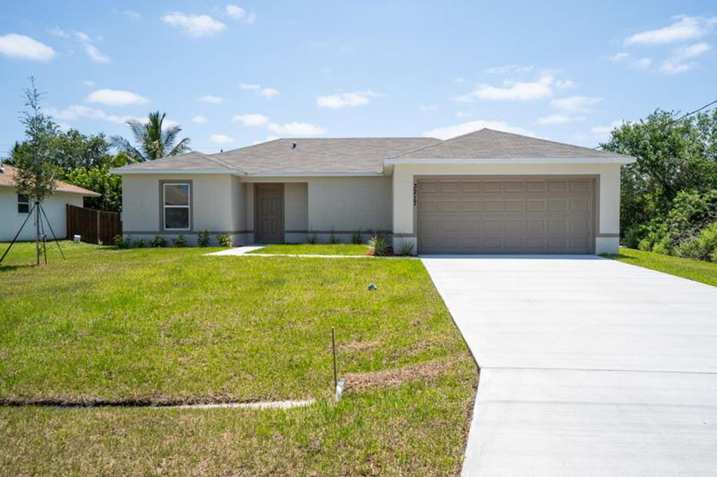 Photo of 407 SW Lacroix Avenue, Port Saint Lucie, FL 34953 (MLS # R10691093)