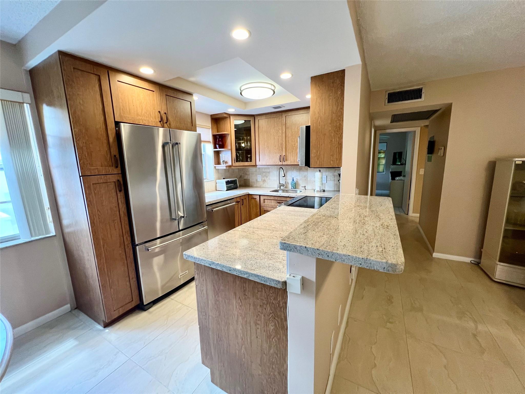 BEAUTIFULLY REMODELED CORNER CONDO WITH A EXPANSIVE WATERVIEW FROM YOUR BACK PATIO! MUST SEE TO APPRECIATE! VERY CLOSE TO CLUBHOUSE! THIS LOVELY HOME IS A RARE FIND! KITCHEN BOASTS HIGH END CABINETRY, STAINLESS APPLIANCES, RECESSED LIGHTING, XL STORAGE, GRANITE COUNTERS W/BAR HEIGHT SEATING AREA. RENOVATED TWO FULL BATHROOMS EACH HAVE COMFORT HEIGHT VANITIES, GRANITE COUNTERS, CLEAR SHOWER & BATHTUB DOORS AND NICHES. YOU WILL LOVE THE LARGE SHOWER STALL WITH TWO SHOWERHEADS TO START YOUR DAY! DID I MENTION THE 20 BY 20 TILE FLOORING IN THE LIVING AREAS OF THE CONDO...STUNNING! ELECTRICAL PANEL HAS BEEN REPLACED. BEDROOM CLOSETS HAVE CLOSET CABINETRY. SOUTHERN EXPOSURE! FULLY FURNISHED. NEW ELEVATOR IN BLDG..RESORT STYLE AMENITIES, PICKLE BALL, POOLS, SO MUCH MORE...ASSOCIATION CLAIMS 55+