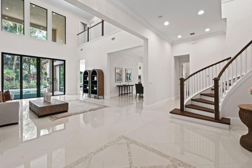 Welcome to luxurious living in the exclusive gated community of Gardenia Isles! This stunning residence offers an unparalleled blend of elegance, comfort and functionality. Upon entering through the elegant wooden double doors, you are greeted by soaring 25 foot ceilings and a grand staircase, setting the tone for the exquisite craftsmanship and attention to detail found throughout this expansive home. Heated pool &  hot tub. Over 5,000 SF of meticulously designed living space. The main level features a thoughtfully laid out floor plan with high ceilings, a formal dining rom, and a huge kitchen equipped with top-of-the-line Thermador appliances. Boasting 5 bedrooms + office, 5 full bathrooms, 2 half baths, including a cabana bath for the heated pool and spa. Furnished annual lease. Primary and office down. 4  bedrooms + loft up. Hurricane impact windows.