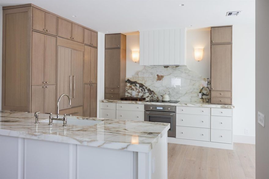 Rarely available first-level unit in Pebblewood, offering a completely renovated, sophisticatedly designed residence. This exceptional property features a heated and chilled pool and a completely private backyard, ideal for year-round enjoyment and entertaining.The home offers a large driveway with ample parking and is just a short walk to the clubhouse. Interior enhancements include expanded bedrooms, laundry in-unit, and a thoughtfully curated selection of premium finishes throughout.The designer kitchen is equipped with Thermidor appliances, complemented by white oak flooring, limestone, and marble finishes.A rare opportunity to own a turn-key, first-level residence combining privacy, luxury, and convenience in one of Pebblewood's most desirable locations.