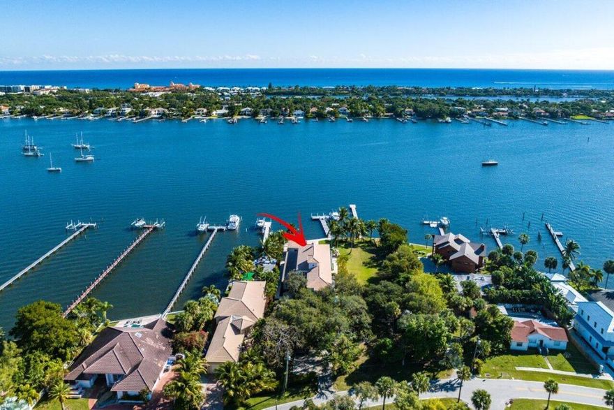 Absolutely stunning coastal direct Intracoastal estate situated on one of the widest sections of the Intracoastal waterway. Entertain in magnificent style with the perfect blend of modern high-tech sophistication and luxury coastal elegance that any entertainer would appreciate. Front double door enters to 22' wood beam soaring ceilings and wide open living spaces provide a clear view of the Intracoastal and heated rock waterfall pool. Unique features include a glass dual-sided wood-burning fireplace separating formal and casual living spaces, multi-tray ceiling and woodwork coupled with stained crown molding and trim provide a striking contrast that makes this home stand above the rest. Gourmet custom chef's kitchen is finished with gas cook top range, massive cooks island, two sinks... ...wall oven and breakfast area. Downstairs master bedroom has wide open water views, his-and-her walk in closest and private dressing area. Master bath has Jacuzzi tub and giant two person shower with imported glass tile finish. Upstairs features include loft/billiard room, sitting area perfect for gamers or television area, three bedroom suites and formal office/study. Third upstairs bedroom can be used as private guest suite with separate staircase. Expansive upstairs covered porch with pecky cypress ceiling overlooks the manicured grounds. Giant sliding glass doors that pocket into the wall offering a complete panoramic water view from all areas of the home. Separate guest cabana fitted with all sliding glass doors can be completely opened. Dockage with boat lift and long pier dock keep toys out of the water. Propane gas tank services home generator, pool heater, cook-top range and water heater. Current dock and boat lift are being moved. Details upon request.