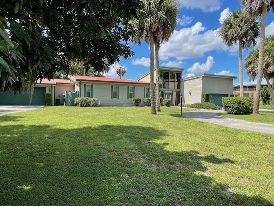 THIS SPACIOUS HOME IS SITUATED ON 2 LOTS WITH 160 ' OF WATERFRONTAGE.  INCLUDED IS A BOAT HOUSE WITH A BOAT LIFT, A SCREENED FISH CLEANING TABLE AND A SWING FOR COOL EVENING ENJOYMENT.  THERE ARE TWO SPACOUS 2 CAR GARAGES, ONE A DOUBLE THRU ENTRY FOR DIRECT ASSCESS TO THE BOAT HOUSE AND BOAT RAMP.  ACCESS TO THE LAKE IS JUST 5 MINUTES TO THE LOCK WHERE YOU THEN HAVE ACCESS TO ANY WATERFRONT PROPERTY IN THE WORLD FROM YOUR OWN BACK DOOR.  THIS IS A LARGE SPACIOUS HOME WITH 3 MASTER SUITES, OPEN FLOOR PLAN, FAMILY ROOMS AND RELAXING VIEWS OF THE WATERWAY.  IT ALSO HAS THE POTENTIAL TO ADD A 4TH BEDROOM AS ONE SUITE HAS A VERY LARGE SITTING ROOM. 
THE STYLE TYPE IS THAT OF FRANK LLOYD WRIGHT WITH THE LARGE OPEN ROOMS AND VAULTED CEILINGS WITH THE BEAUTIFUL BEAMS THROUGHOUT THE LIVING ROOM.