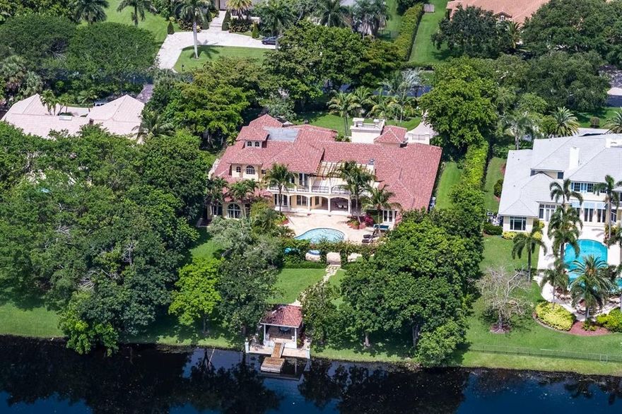 One-of-a-kind Masterpiece, thoughtfully built and located in the highly sought-after Fieldbrook Estates of Boca Raton, is finally available for you to call your Home. Nestled on an elegantly manicured 1-acre lakefront lot with a private Gazebo and floating Dock, this majestic 2-story mansion was beautifully crafted with exquisite finishes in 2002. It charms with its tranquil water views, priceless canopy of mature Palms, Spanish Oaks, Bougainvillea and lush landscaping. Upon entering through dramatic double door foyer, the beauty of this 9,674-square-foot estate lies in the details. In addition to 4 bedrooms, 5 full and 2 half baths, the property features office with its private entrance, game room, hobby room, gym/yoga studio, laundry room, outside cabana and summer gas kitchen.