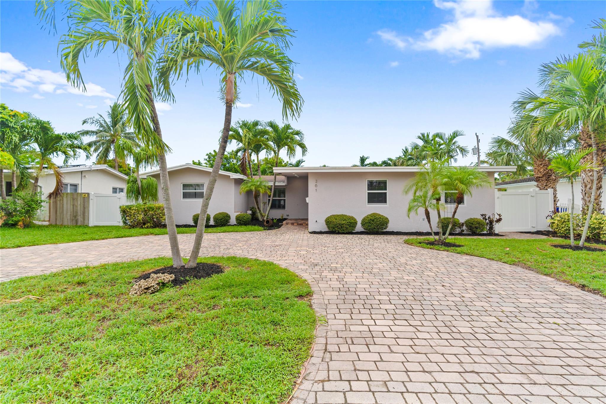 This beautifully updated 4-bed, 3-bath Pompano Beach pool home offers space, comfort, and privacy in one of the area’s most welcoming neighborhoods—ideal for families or multigenerational living. The split-bedroom layout includes two spacious primary suites with en-suite baths and walk-in closets—great for guests, aging parents, or grown children. One suite has a private entrance for flexibility. The open-concept living area flows into a bright kitchen with quartz counters, soft-close cabinets, and stainless appliances. Wood-look tile floors, crown molding, and coastal touches create a relaxed vibe. Enjoy a heated pool, spa, indoor laundry, plantation shutters, updated baths, and easy access to the beach, golf, parks, and shopping.