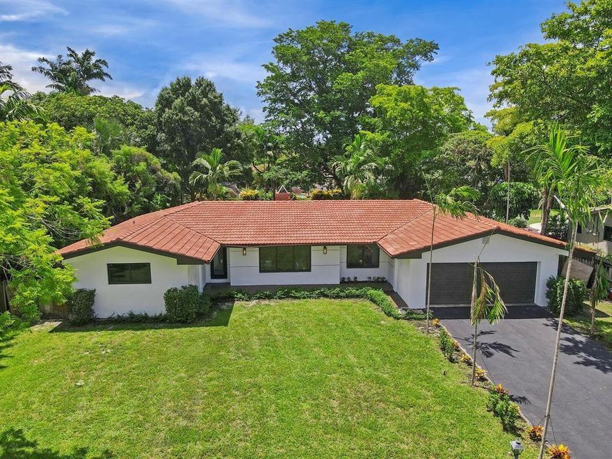 Welcome to this spacious 3-bedroom, 2-bathroom home situated on a massive lot in the heart of Plantation. Boasting a functional layout with a stacked bedroom plan and a versatile den perfect for a home office.  The interior features elegant marble flooring throughout the main living areas. Significant upgrades include a barrel tile roof and a 2-car attached garage. The expansive backyard is fully fenced, providing a private oasis with ample room for outdoor living or parking multiple vehicles/boats. Located in the desirable Country Club Estates with no HOA, you are minutes from top-rated schools like Plantation Park Elementary. Sold As-Is. Don't miss this incredible opportunity!