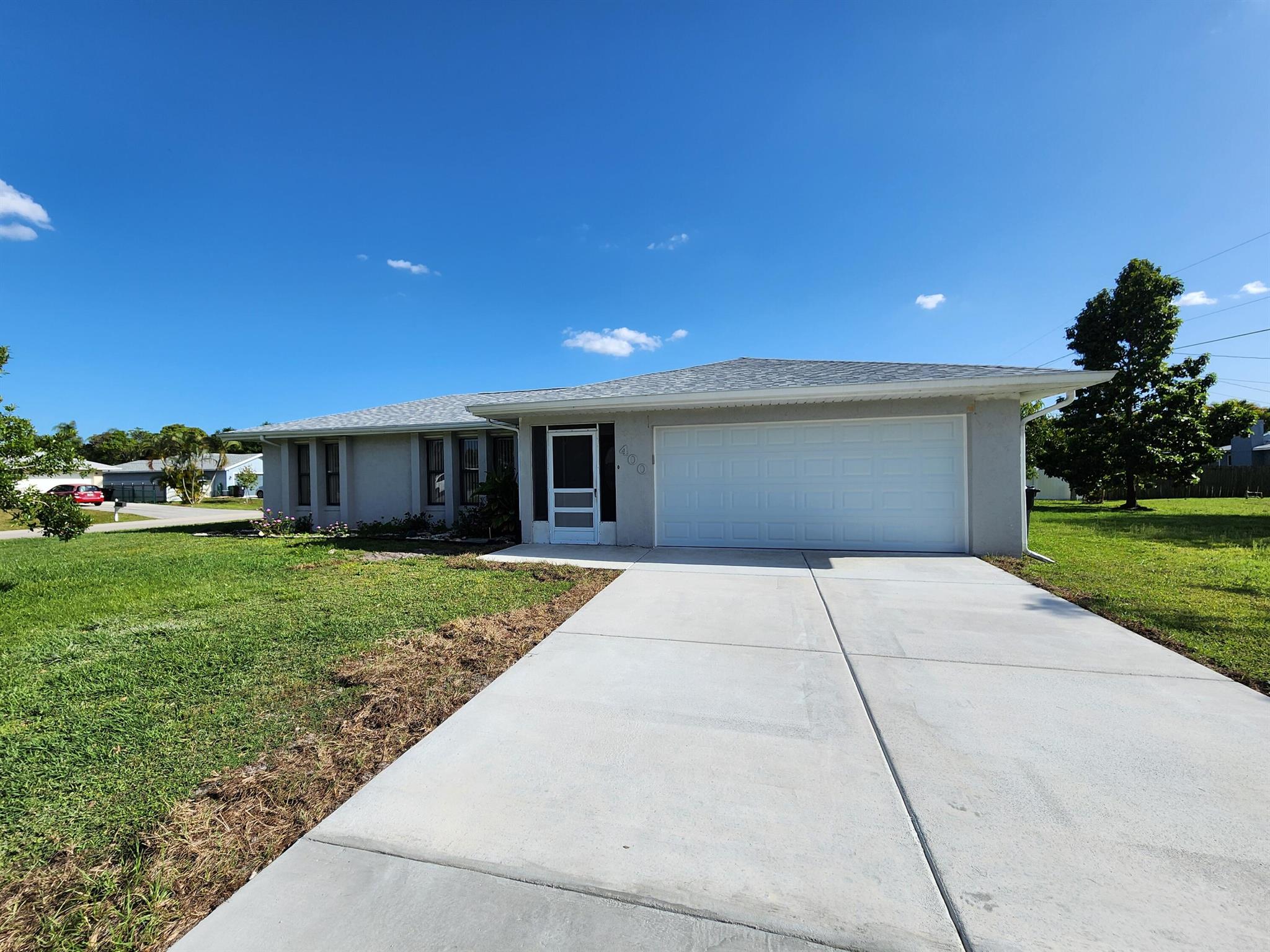 Charming 2-Bed, 2-Bath Home for Rent in Port St. Lucie!This beautifully maintained 2-bedroom, 2-bath single-family home with a 2-car garage offers 1,574 sq ft of comfortable living space on a spacious corner lot. Enjoy a generous backyard with mature fruit trees--perfect for relaxing or entertaining. -Freshly painted and pressure-washed -Brand new roof (2025) and brand new driveway -Granite countertops in kitchen and bathrooms -Plenty of storage throughout -Bright, open layout with lots of natural light This home is move-in ready and waiting for its new tenants to settle in and make it their own. Don't miss this gem & schedule a showing today!