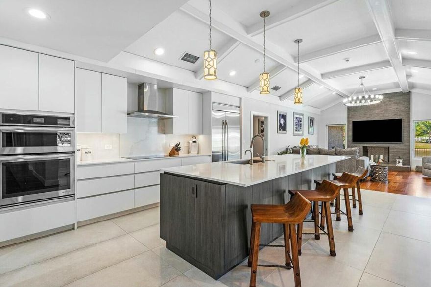 Prime oversized lot at the end of a quiet cul-de-sac, this fully renovated home offers the ultimate in luxury and convenience. Boasting a stunning location with lake views, the expansive front, side, and backyard provide ample space for outdoor living and activities. Step outside to an oversized pool and a travertine pool deck, perfect for entertaining in style. With impact doors and windows, new A/C's, and an instant hot water heater, this home is as functional as it is beautiful. The real hardwood floors throughout (except the kitchen) add warmth and charm, while the master suite features a large walk in closet and a spa-like shower for ultimate relaxation. Located just minutes from the Turnpike and I-95, this home truly has it all - a perfect blend of modern upgrades & comfort.