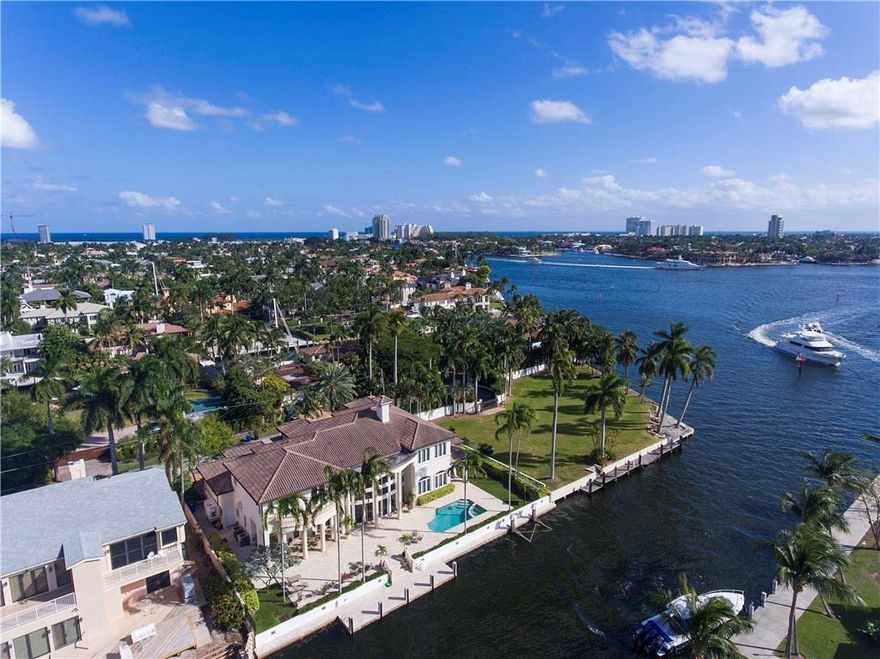 Magnificent water views sweep to the New River and Intracoastal from this impressive Modern Mediterranean estate fronting 125± ft. on the grand Lido Canal, one lot from the point, with prime dockage for a 100±-ft. yacht. A fabulous entertaining space, opening to the waterfront’s sprawling pool terrace, the spectacular 2-story window-walled great room features a fireside sitting area, media area and professional-style bar. Paneled office/billiard room. Ultra-luxurious first-floor master suite.