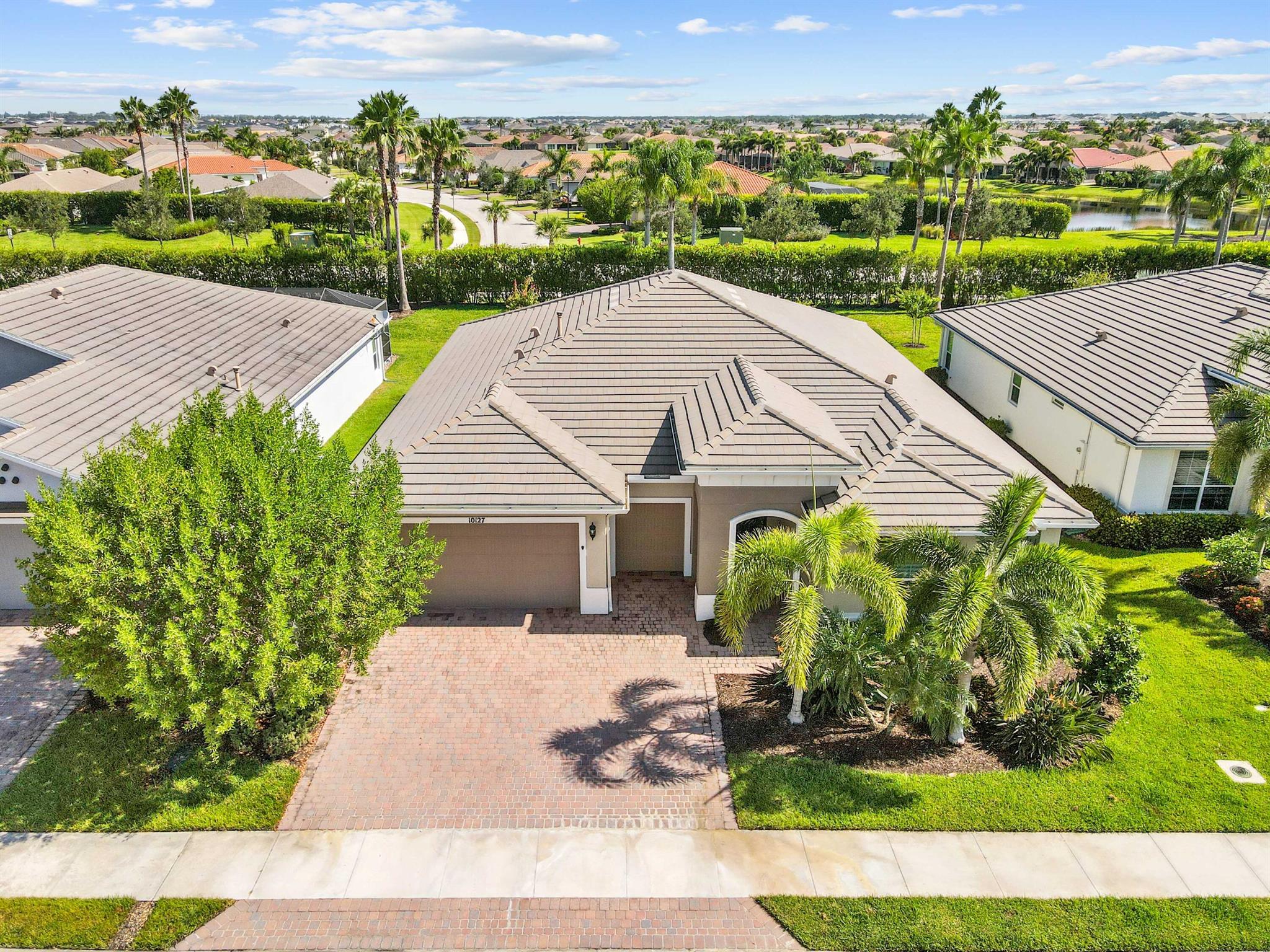 Welcome to Vitalia at Tradition, a premier 55+ manned-gated community offering resort-style living at its finest! This spacious single-story home features 3 bedrooms, 2.5 bathrooms, a versatile den/office, and 2,446 sqft of comfortable living space.Equipped with a Generac whole house generator, air filtration system, impact windows, and plantation shutters, this home offers both comfort and peace of mind. A 2-car garage plus dedicated golf cart space adds extra convenience.The kitchen is a chef's dream, featuring a gas cooktop with double ovens, quartz countertops, stainless steel appliances, and a large island with bar seating--ideal for entertaining and everyday living.