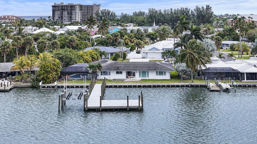 Beautifully renovated home in prime location on the deep water protected Faber Cove. Walk in and wow! Full wall of windows with amazing water views. Watch the dolphins playing and fish jumping.  Light and bright open floor plan with modern finishes and large windows to enjoy that great view. New seawall & new top-quality super-large dock & lift. Remodel includes all cabinets and counters, impact glass windows and doors, and lovely floor tile throughout. Large screened and heated waterfront pool to enjoy all year. Bring your 50, 60, 70-ft boat and all the toys. No fixed bridges; you are out in the ocean in minutes. The only house for sale now directly on Faber Cove--a rare gem! World-renowned fishing, boating, restaurants, beaches. You can't buy a home like this anywhere else. Call today!