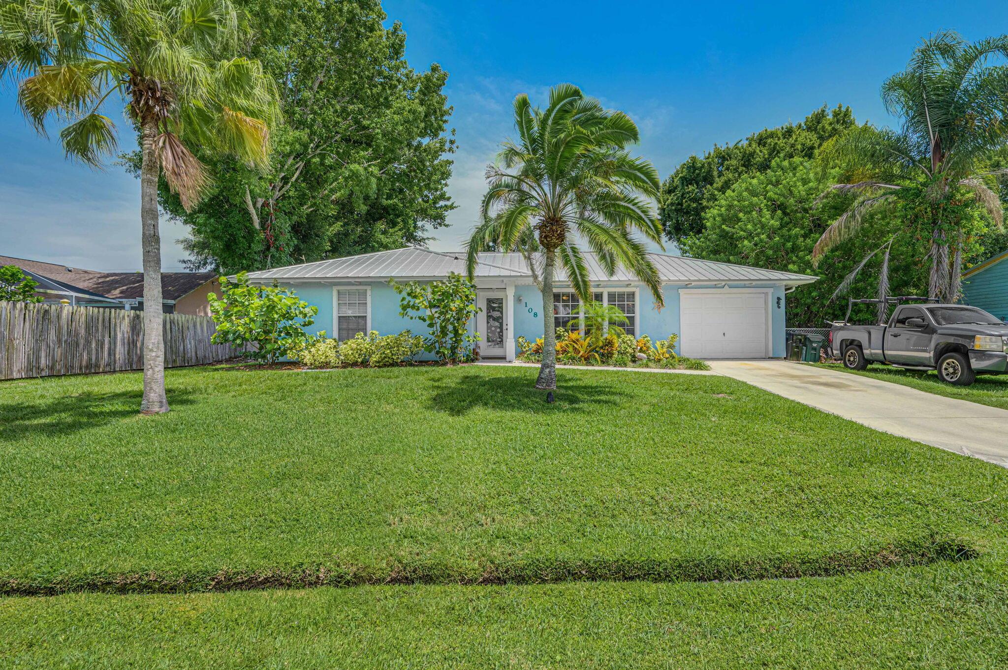 Nestled in a quiet and desirable neighborhood, this meticulously maintained property offers the perfect blend of comfort and elegance. Updated kitchen with modern appliances and ample storage space. Metal Roof! Large bonus room perfect for entertaining which leads out to your very own tropical oasis, two decks, fire pit , and several cozy sitting areas. Bright and airy living room, perfect for relaxation and gatherings. BRAND NEW AC UNIT, DUCT WORK, BLACKLIGHTS AND FILTERS! New Vinyl Flooring, washer/dryer, electrical panel, toilets and more! Close to beaches, shopping and the interstate. Don't miss out on the opportunity to own this beautiful home in Port Saint Lucie. Schedule a showing today and envision yourself living in this charming neighborhood!