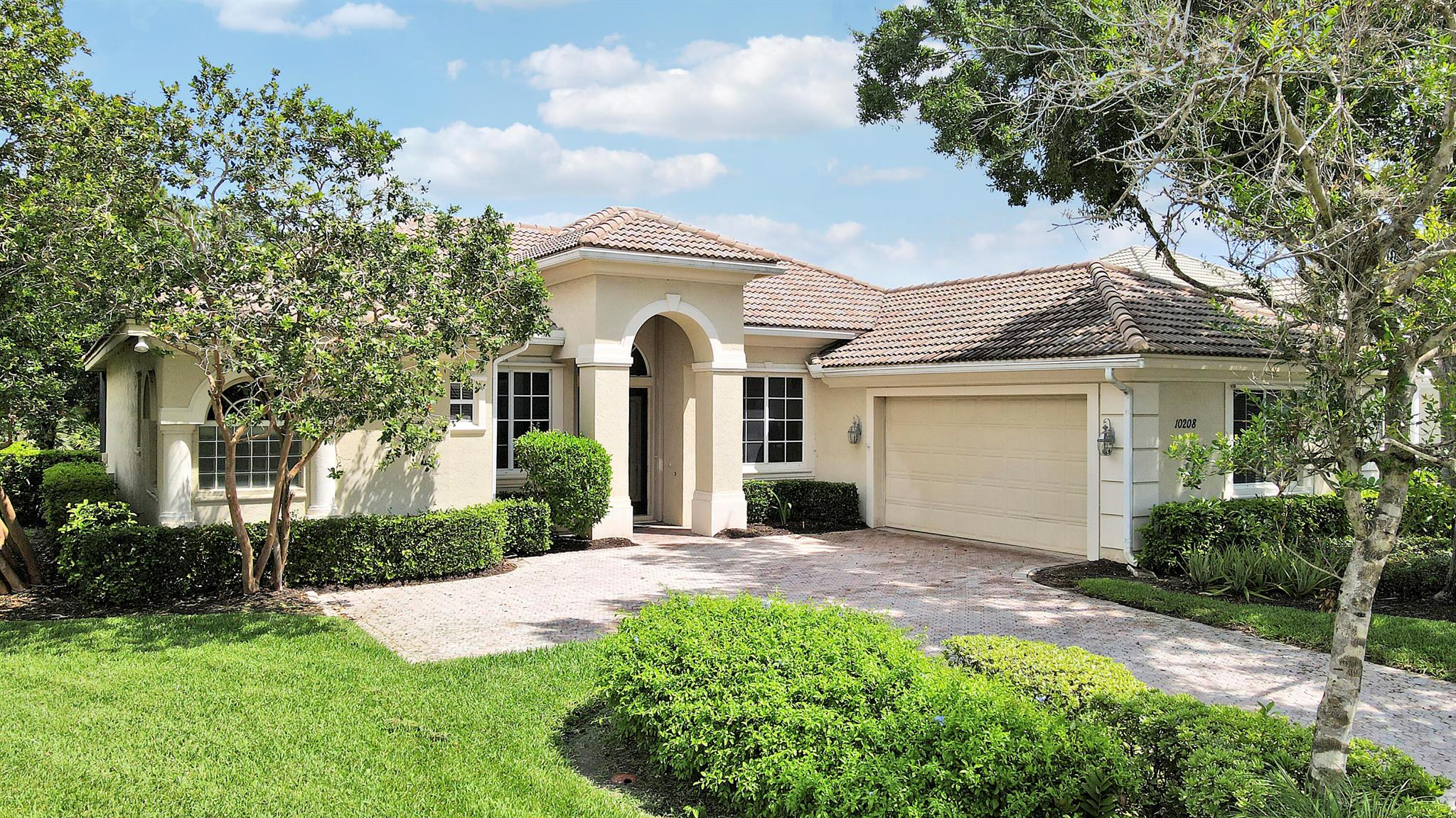 FANTASTIC VALUE IN PGA VILLAGE! Nestled on the 17th tee of the Ryder Course with a park-like setting and golf views! This 3BR+Den/2BA/2.5CG home has been lovingly enjoyed and has many charming features including built in shelving, a breakfast room, tall ceilings, dual glass entry front doors, a split bedroom floor plan, multiple doors leading out to the lanai, oversized garage with room for your golf cart and newer AC (2021). The spacious living area is brimming with light and overlooks the back yard. Kitchen opens to the breakfast room, has newer SS appliances, solid surface counters and a breakfast bar. The master suite has a large walk-in closet, access to the patio as well as an ensuite with dual vanities, walk-in shower and soaking tub. Two additional bedrooms share a hall bath.
