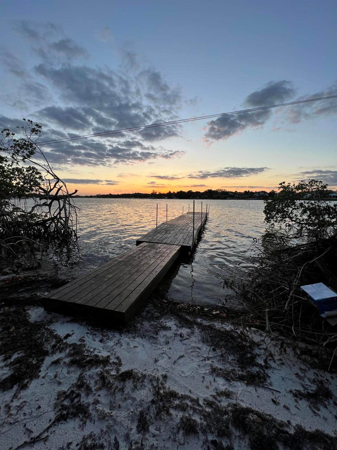 This is the Only piece of property in Jupiter with over 1000 feet of waterfront and it comes with your own private island! With 10,000 sqft cleared and a current buildable space around 5-6,000 sqft. You can get variances and mitigation to build a much larger home. Currently has as a DEP permit to build a ~100 ft. Dock. Mangroves can be trimmed down significantly (per certified mangrove expert that surveyed the property). Enjoy the tranquil outdoor space, appropriate for relaxation or entertaining guests. With its convenient location, you'll have easy access to local restaurants like 1000 North, The Woods and the Love street district all within 1 mile. Don't miss the opportunity to make this charming property your own retreat.