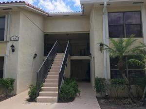 Great first floor unit in the desirable community of Palm Beach Grande! 2 bedroom, 2 bath all tile floor unit with a serene and peaceful lakeview! Neutral throughout! Great unit. The association allows you to rent right away! Come and see it today!