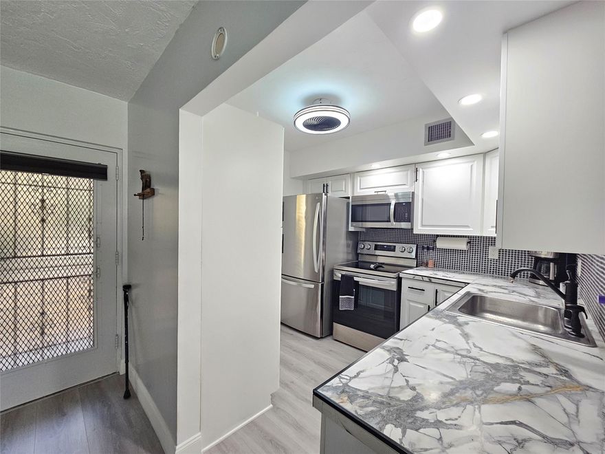 TOP OF THE LINE!! Completely updated spacious 1 bedroom, 1 bathroom corner unit 1st floor condo. Updated open kitchen white modern cabinets. Stainless appliances. Tile backlash. Large pantry for extra storage. Porcelain counter top. Updated bathroom. Tile & Waterproof flooring. New lighting and ceiling fans. Fully furnished with NEW modern furniture 2023. Water Heater 2019. A/C 2019. Bright unit w/ lots of natural light. Open Florida room with IMPACT WINDOWS. Enjoy a relaxing garden views. Great location Unit located next to the pool, Amenities & Clubhouse. Located in Building B Well managed & well maintained building. Welcome to Somerset Phase 2 active 55 plus gated community. Many activities & amenities.  Minutes to shopping & Restaurants. Welcome Home.  MUS SEE!!