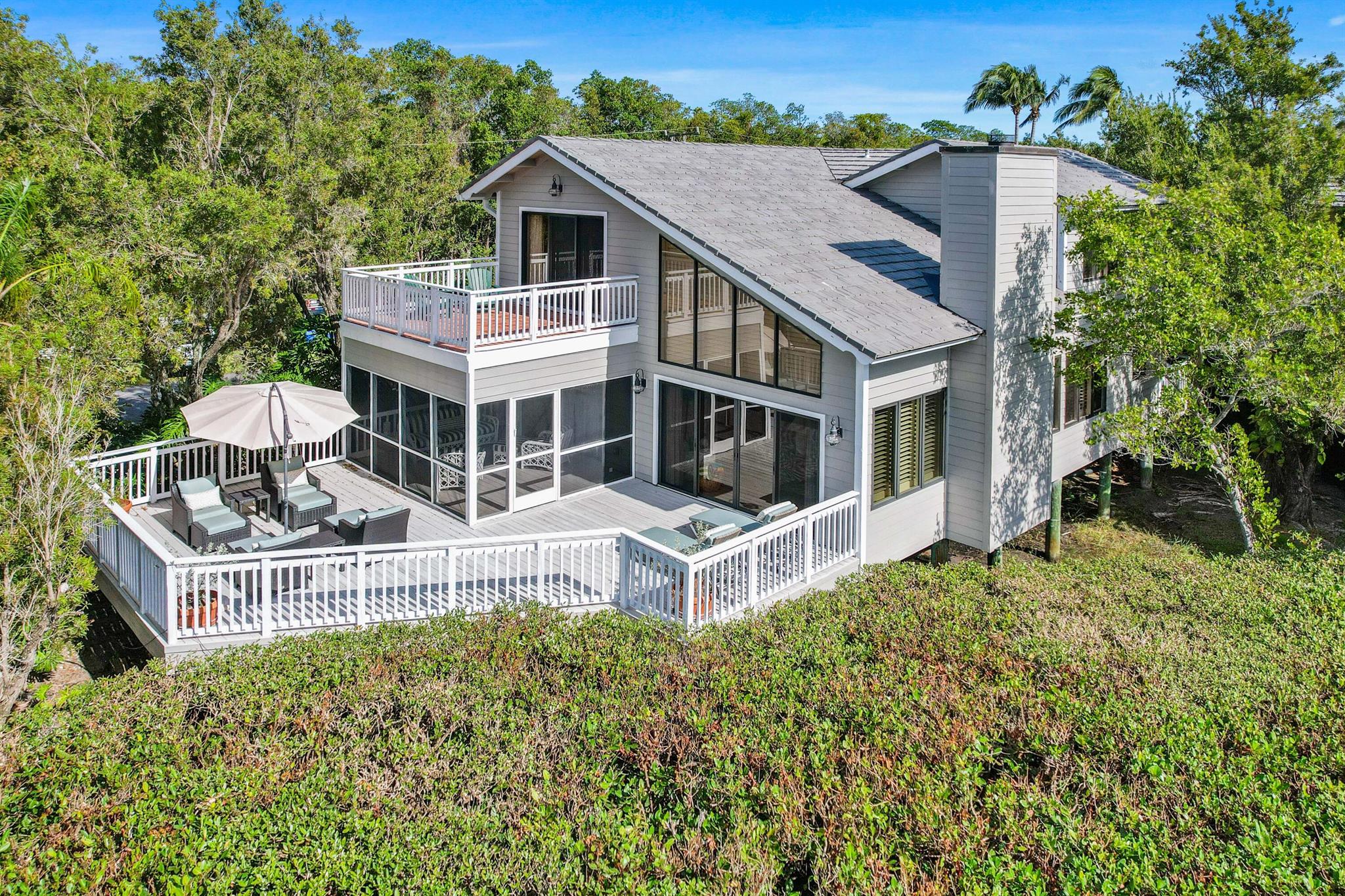 From the moment you arrive, you are welcomed to Florida casual living at its best. Inside this spacious, split-level coastal retreat you will discover a traditionally coastal palette, a fully renovated chef's kitchen, plenty of windows, hardwood floors and a vaulted pecky cypress ceiling in the living room. The main bedroom, kitchen, living room and dining area enjoy the convenience of the first level which incorporates access to two large deck spaces for casual dining or relaxing. The upper level presents two spacious en-suite bedrooms as well as a large bunk room with access to a private full bathroom. Some of the best marina views can be captured from the upper terrace located off the second bedroom suite, which could also serve as a second master bedroom. Being offered furnished.