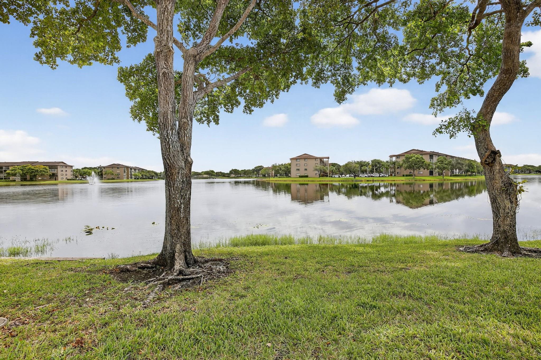 Enjoy lakefront living in the newest section of Century Village, Pembroke Pines with this spacious ground-floor Karanda model. Featuring a smart layout with two walk-in closets, a galley kitchen with breakfast nook, and AC replaced in 2022, this well-maintained unit offers comfort and convenience with parking near the entrance. Residents enjoy resort-style amenities including pools, golf, tennis, pickleball, clubhouse events, and 24/7 security with courtesy transportation. Monthly fees include water, cable, and internet. Association requires a 650+ credit score, no rentals for the first 2 years, a max of 3 occupants (owner must reside), and a limit of 2 cars (1 per person). Located near excellent dining, shopping, and entertainment options.