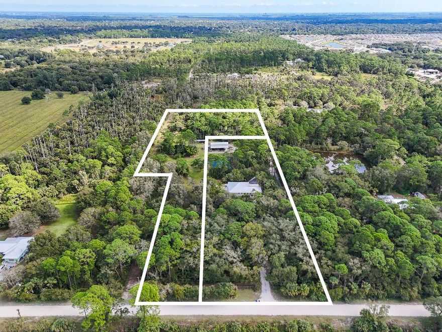 North Fort Pierce - 6.5 Acres on Two Parcels
Welcome to this unique opportunity just off Indrio Road in North Fort Pierce, an area projected for significant growth and the future home of Buc-ee's. Spanning 6.5 acres across two parcels, this property offers versatility, space, and modern living.
The main residence is a newer CBS home featuring three bedrooms, two bathrooms, and a two-car garage. It is built with a durable metal roof and finished with slate tile flooring throughout. The kitchen is bright and inviting, with white cabinetry paired beautifully with sleek black granite countertops and stainless-steel appliances and a subzero refrigerator. All windows and doors have hurricane impact. Adding even more value, the property includes a spacious barndominium on its own septic and electric meter. The ground floor offers an open area ideal for projects or storage, while the second floor provides two bedrooms and two bathroomsperfect for guests, extended family, or creative living.
Additional structures and dog pens enhance the property's functionality, making it suitable for a variety of uses. With showings beginning tomorrow, this is a rare chance to secure this property in one of North Fort Pierce's most promising locations.