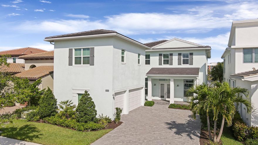 This stunning estate home rests on of the best premium lots with sweeping lake views and is situated close to the community clubhouse with all its amenities. Entering through the front doors, you are greeted to an expansive, show-stopping marble foyer that seems to stretch effortlessly out over the travertine deck that houses the 16x32 heated saltwater pool and spa. This is open concept living at its finest. The luxuriously appointed home features a top-of-the-line chef's kitchen with 4 ovens, a built-in refrigerator, GE monogram appliances with double stacked premium cabinetry that stretches 13ft high, a quartz countertop and waterfall island with matching cabinetry veneer. Attention to detail is present in every aspect of this home.