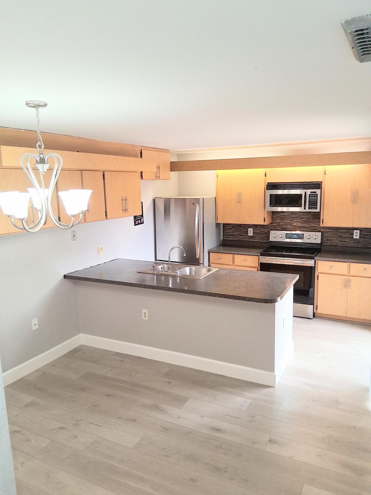 SPACIOUS, UPDATED TOWNHOUSE in the beautiful Village Of Sandalwood Lakes South Community! Updated kitchen w/ stainless steel appliances, over-the-range microwave, mosaic glass backsplash, Laminate flooring throughout, ceramic tile in bathrooms, walk-in closet, central a/c & heat, ceiling fans, indoor washer & dryer, storage, fenced patio and so much more!!! Call TODAY to schedule a showing!!
