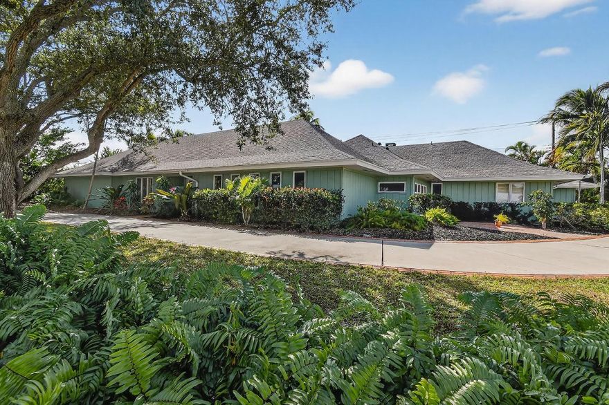 Nestled on an over-sized corner lot in the exclusive Tequesta Country Club Community, this custom built home boasts over 3,700 square feet of living space. Views of an expansive saltwater pool and covered patio are available from throughout the interior of the home. Lush palms create a private backyard oasis that invites poolside tranquility or year-round entertaining. The home also boasts a 56' long garage, perfect for your boat, RV, cars or any other toys that your lifestyle requires. 
The home's interior is bathed in an abundance of natural light. The open concept kitchen features a spacious center island with an extra sink and ample counter space. Other features include; a master suite with separate his and hers bathrooms, a family room with a wood-burning fireplace, built-in shelves and wet bar, and a generous sized living room with a volume tray ceiling. 

The home is located just a short distance from Tequesta Country Club's two riverfront parks and the community's boat ramp and day dock. All are situated along the 'Wild & Scenic' designated Loxahatchee River. Water enthusiasts will not be disappointed, while the golfer in the family has unlimited opportunities in the region. Tequesta Country Club Community residents are also offered a wealth of dining, shopping and beach options in the area.