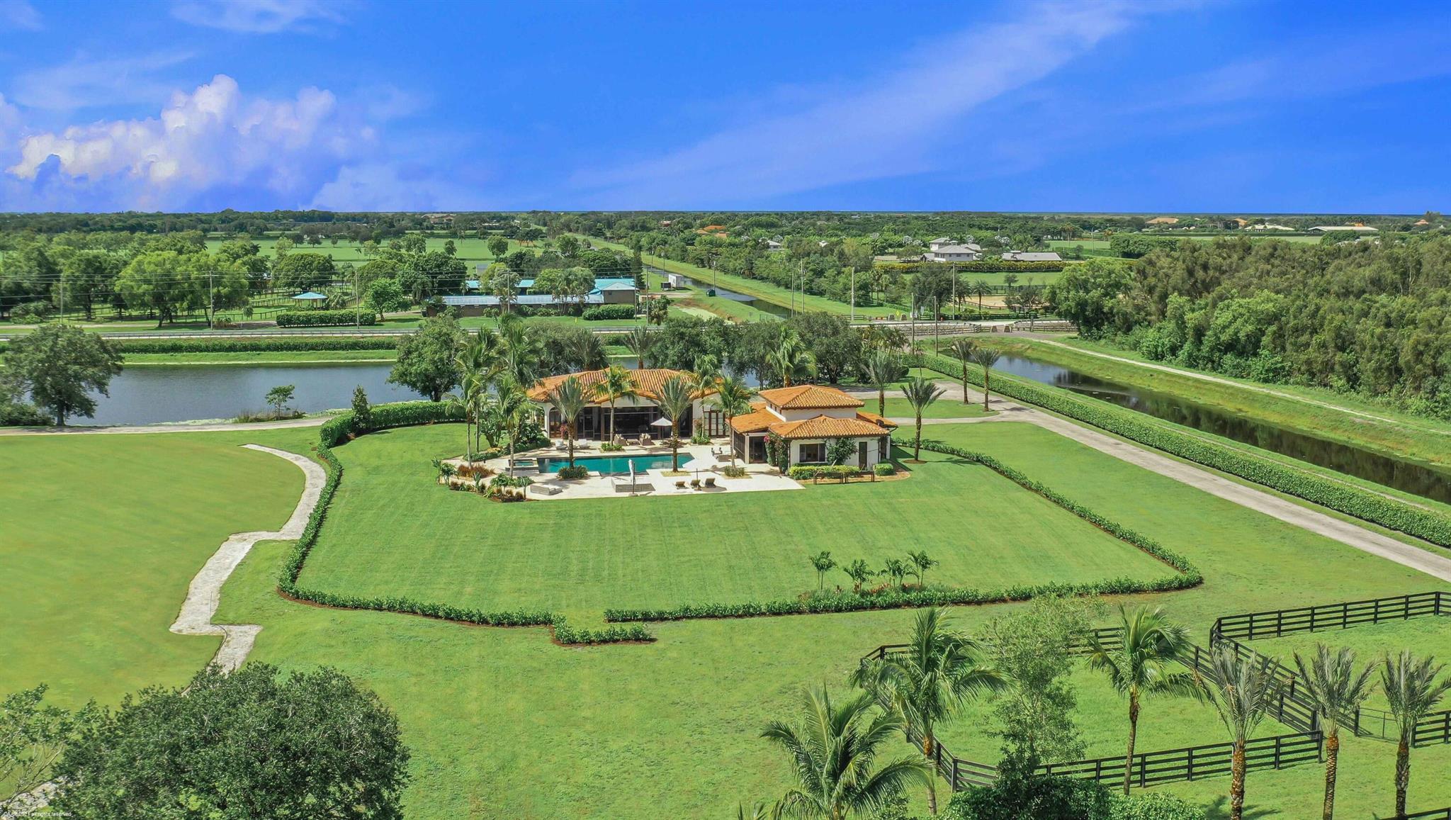 Experience the equestrian season in unparalleled luxury in this stunning 3,700 sq ft Main home and Guest House included, located just steps from Wellington International! Built in 2015, this home boasts 5 spacious bedrooms and 5.5 bathrooms. An open living room and kitchen equipped with premium Sub-Zero and GE Monogram appliances.The expansive primary suite offers a dedicated office space, dual walk-in closets, and a spa-inspired bathroom.Guest house: separate 1-bedroom, 1-bathroom pool house awaits, complete with a full kitchen, gym, and sauna. Unwind by the impressive 25' x 50' heated pool or relax in the large screened-in patio, which includes a summer kitchen perfect for entertaining. Enjoy convenience with just a quick, under-five-minute golf cart ride to the show grounds.