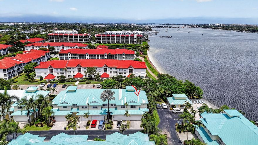 Welcome to Barefoot Cove, where coastal living meets everyday luxury. This rarely available east-end residence offers breathtaking Intracoastal views from most rooms, filling the home with natural light and serene waterfront vibes. The thoughtfully designed open-concept first floor features tile throughout and a seamless flow perfect for both relaxing and entertaining. Upstairs, you'll find laminate flooring throughout, adding warmth and continuity to the living spaces. Enjoy peace of mind with A/C replaced in 2022 and hot water heater in 2025. Barefoot Cove is a charming Key West-style waterfront community offering resort-style amenities including a pool directly on the Intracoastal and a private beach, ideal for soaking in South Florida's coastal lifestyle.   Whether you're looking for a full-time residence or seasonal escape, this home delivers waterfront living at its finest in an unbeatable location. Exterior building insurance included in HOA fee
