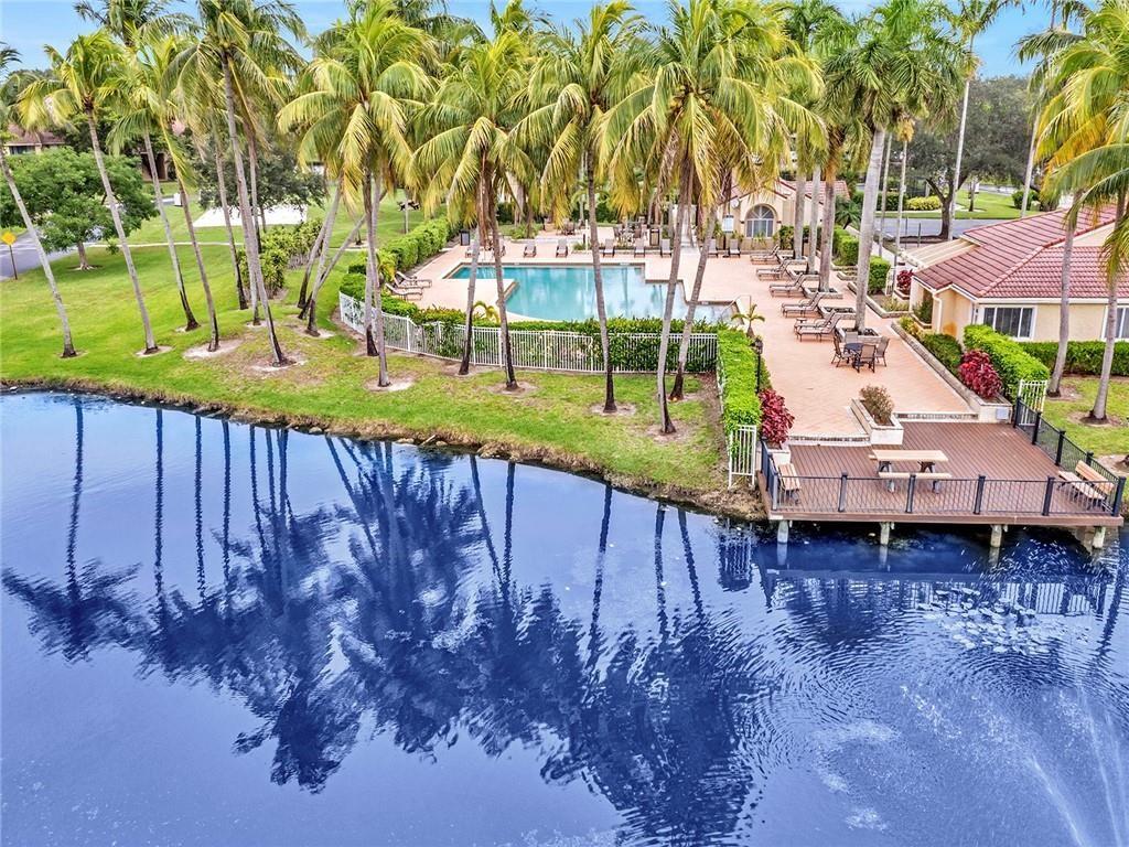 Stunning first floor corner unit in sought-after Coco Parc with incredible lake views. Rarely available! Largest one bedroom floorplan with newly renovated bathroom, tile throughout, full size washer and dryer in unit. All new stainless steel appliances. Light and bright, freshly painted in neutral tones. Storage unit on patio/balcony. Resort style amenities include sparkling pool, tennis, fitness center and basketball. Across the road Windmill Park offers a playground, dog park, tennis, basketball courts and much more! Public boat dock just a few blocks away with access to 123 miles of canals (C14). Walk to shopping and dining, easy access to the Turnpike.