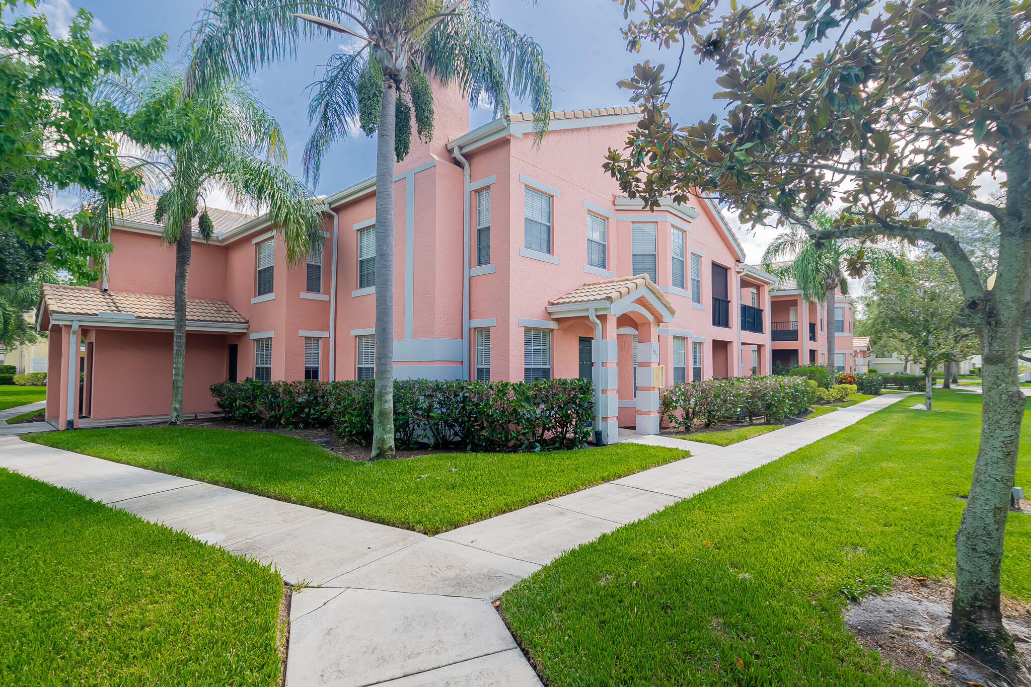 Rarely available ground floor, corner unit in The Belmont--a gated community in St. Lucie West offering resort-style amenities including a heated pool & spa, fitness center, tennis court, multimedia room, and valet trash service. This 3BR/2BA condo features a spacious layout with no carpet--laminate, tile, and vinyl flooring throughout. The open kitchen offers plenty of storage and flows into a generous living space. The primary suite boasts a walk-in closet, Roman tub, and separate shower. Enjoy the covered patio and in-unit laundry with washer & dryer. Close to shops, dining & I-95--schedule your tour today!
