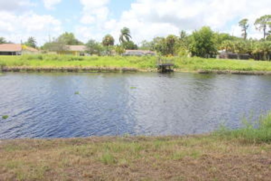 Discover this amazing piece of land right on the water! Enjoy the beatiful waterfront view from your back yard as well as miles of fishing, boating and other water sports. Sitting directly on the sought after C-24 canal in Port St Lucie, this lot is located in a quiet, family friendly, well kept neighborhood. Located several blocks from a city park with a boat ramp, fishing pier, walking trails and much more, not far from 95, the turnpike and Crosstown this area offers something for everyone. Don't miss this opportunity to create your dream home in a tropical paradise. Lot is on the left when looking from the street, walk down the left side of lot to access rear of property and water.