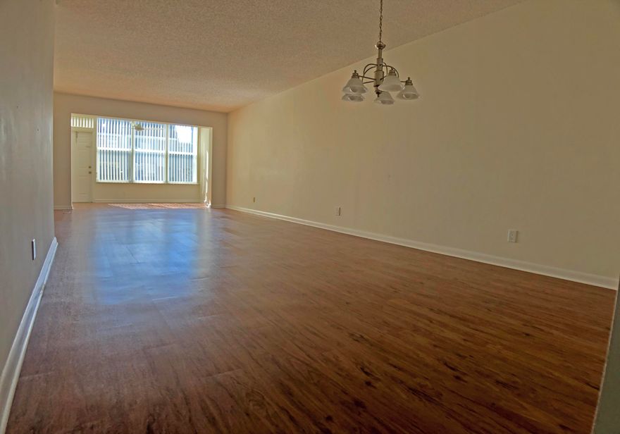 This 2 bedroom 2 bath condo is located on the first floor with assigned parking right in front. It has an eat-in kitchen and a sun room with storage. The floors are laminate except for the tile in the bathrooms and kitchen. The stainless steel kitchen appliances, the in-unit washer and dryer, A/C  and water heater are all relatively new. The windows are impact resistant. The master bedroom has a walk-in closet with organizers.The community has tennis courts, club house and pools. There is also a satellite pool close by. There are lots of guest parking spaces.  Water and cable are included. The community is conveniently located close to the border of Delray and Boca, near to the beach, I95 and shopping and dining.