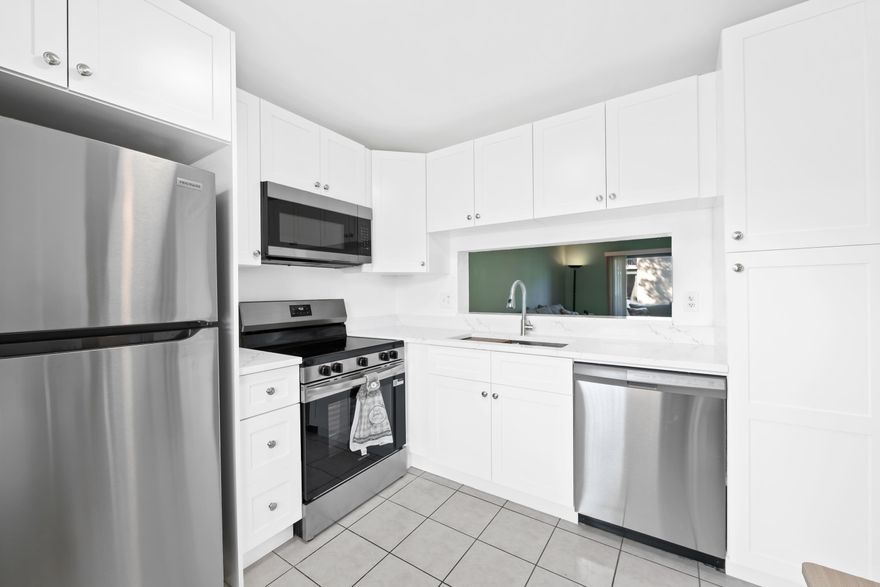 Look no further...This First Floor unit in an all age, tucked away & gated community is move in ready!  Brand new white kitchen w/stainless appliances (2026) *Elec. Panel (2026)*A/C (2021)* Freshly painted interior. Parking spot right up front & unit is located across from the pool for free Vitamin D! Main living area gives access to glass sliders that lead to a private & newly screened (2026) patio...perfect to enjoy the green grass & blue water view. This unit is super secure with IMPACT glass & hurricane SHUTTERS for extra protection. *Washer/Dryer inside your unit* Bathrooms feature both a tub & shower. *Ceramic Tile & Laminate flooring*  Just waiting for a New Owner to call it Home! **Financially Healthy Association ** Low maintenance includes security gate, water, cable & more **
