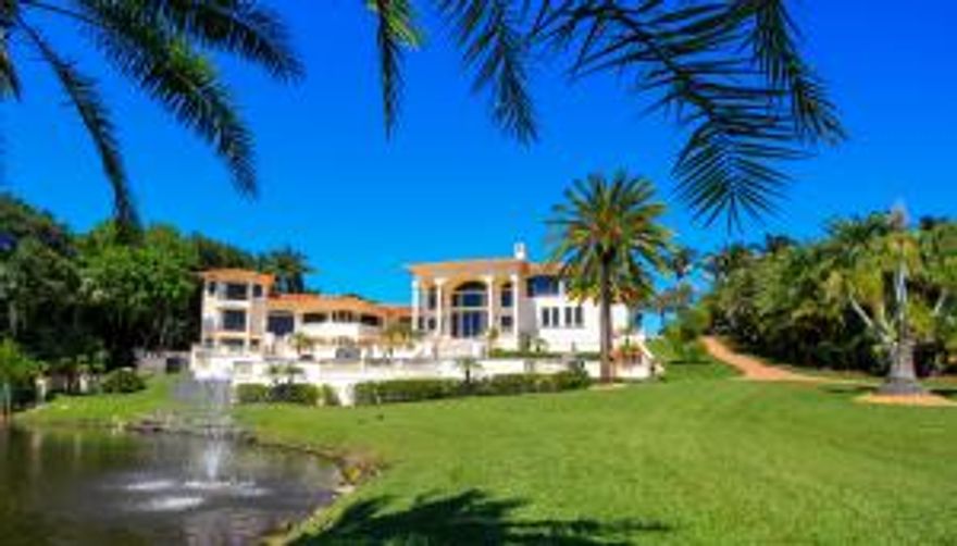 One of the most exclusive waterfront estates towering over the Saint Lucie River offers extensive views of the Northwest & South! Located in prestigious Castle Hill, this stunning 8700sf gated home was meticulously reconstructed in 2006 with impact windows, exquisite chef's kitchen, elevator, separate apartment, home theater & game room, whole house generator, mahogany molding/doors/cabinetry, & imported Italian Breccia marble & granite flooring. The grounds of the 1.7 acre lot offer fountains, playful sta