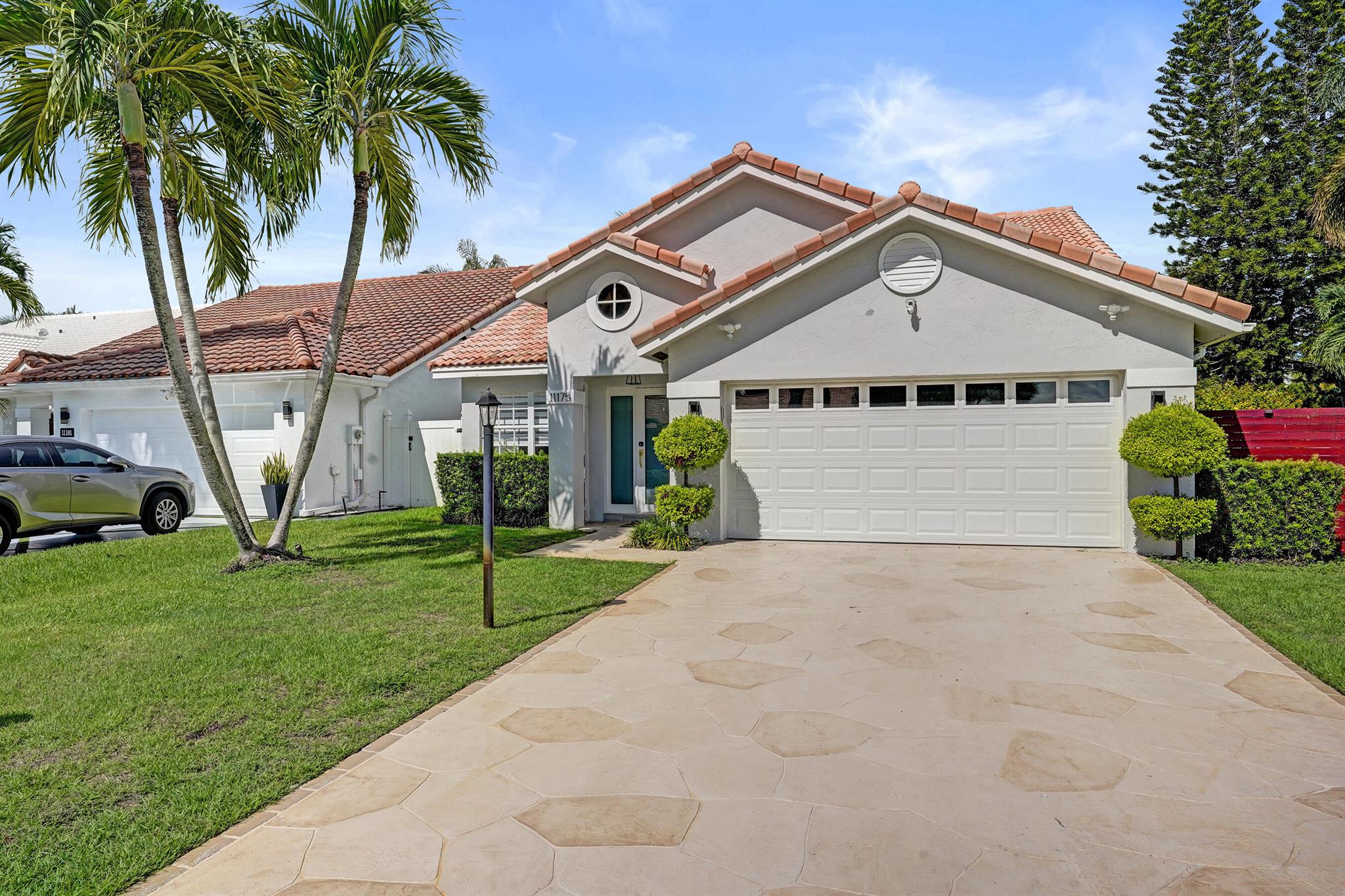 Welcome to one of the most impressive residences ever available for lease in the highly desirable community of Boca Chase. This furnished (or unfurnished) annual rental offers a bright and spacious open-concept layout with a beautiful island kitchen, designed for both style and everyday comfort in upscale west Boca Raton.The home is completely renovated and sits on a rare, tree-lined corner lot with a large, fully fenced backyard and a custom designer pool featuring a sundeck, the perfect blend of privacy, relaxation, and entertaining space. Inside, soaring cathedral ceilings, recessed lighting, and elegant finishes create an airy, inviting feel. The living areas flow seamlessly, enhanced by wood-plank ceramic tile flooring and thoughtful upgrades throughout.