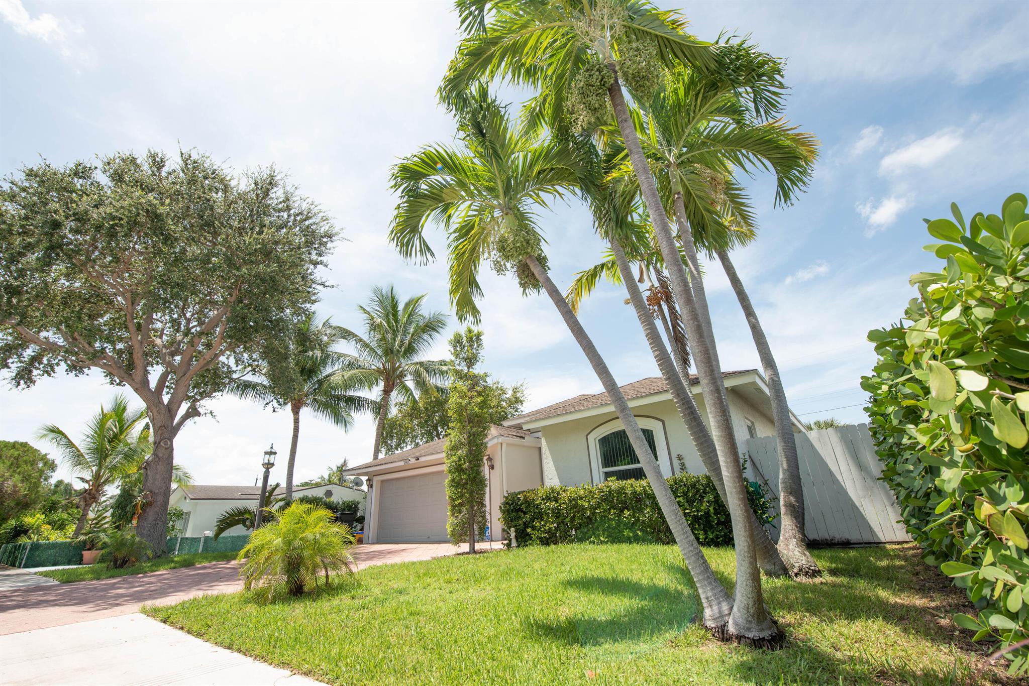 Gorgeous and private coastal home tucked away in one of South Florida's most desirable neighborhoods - Lake Worth Beach's Palmway corridor. Directly across from the historic and beautiful Lake Worth Beach Golf Course. Outfitted with all modern amenities and meticulously maintained. 3rd bedroom features full bath with a private entrance adjacent to front door.Features include 3 bedrooms, 3 baths, 2 car garage, air conditioned Florida room, additional office/study/den, incredibly spacious, open floor plan, and excellent privacy afforded by landscaping and location. Closets feature built-ins, Florida room has dedicated Mini-split air conditioner, Kitchen features modern appliances and very high quality finishes. Beautiful, spacious home in an excellent neighborhood!