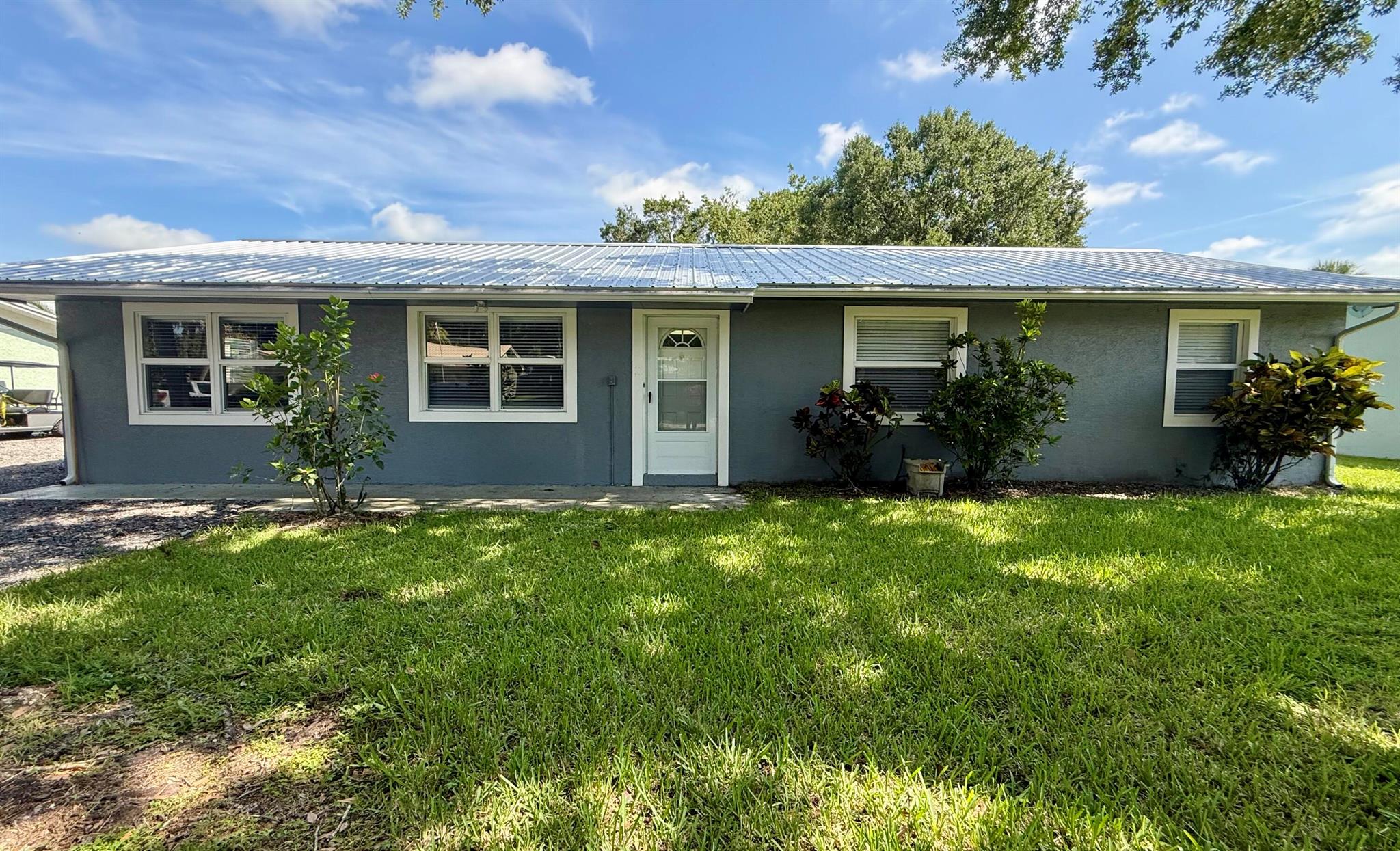 The perfect starter home! This charming 3 bdrm - 2 bath home sits on just under a 1/4 of an acre, located in the desirable SW section of town. The home features an open-concept floor plan with 1380 sq ft of living space and 1854 sq ft of TLA. You'll find peace of mind with a brand new 2025 metal roof, a 2022 AC w/ a Sensi thermostat that can be controlled from your phone, and a 2024 hot water heater. The kitchen boasts beautiful corian countertops with an island, bright white cabinets, and brand new 2024 stainless steel appliances, including a washer and dryer. Additionally, the home offers a large 20x13 enclosed back porch w/ vertical sliding windows & screens all around, perfect for enjoying the outdoors. The front and back yards are graced w/ mature oak trees, providing ample shade.