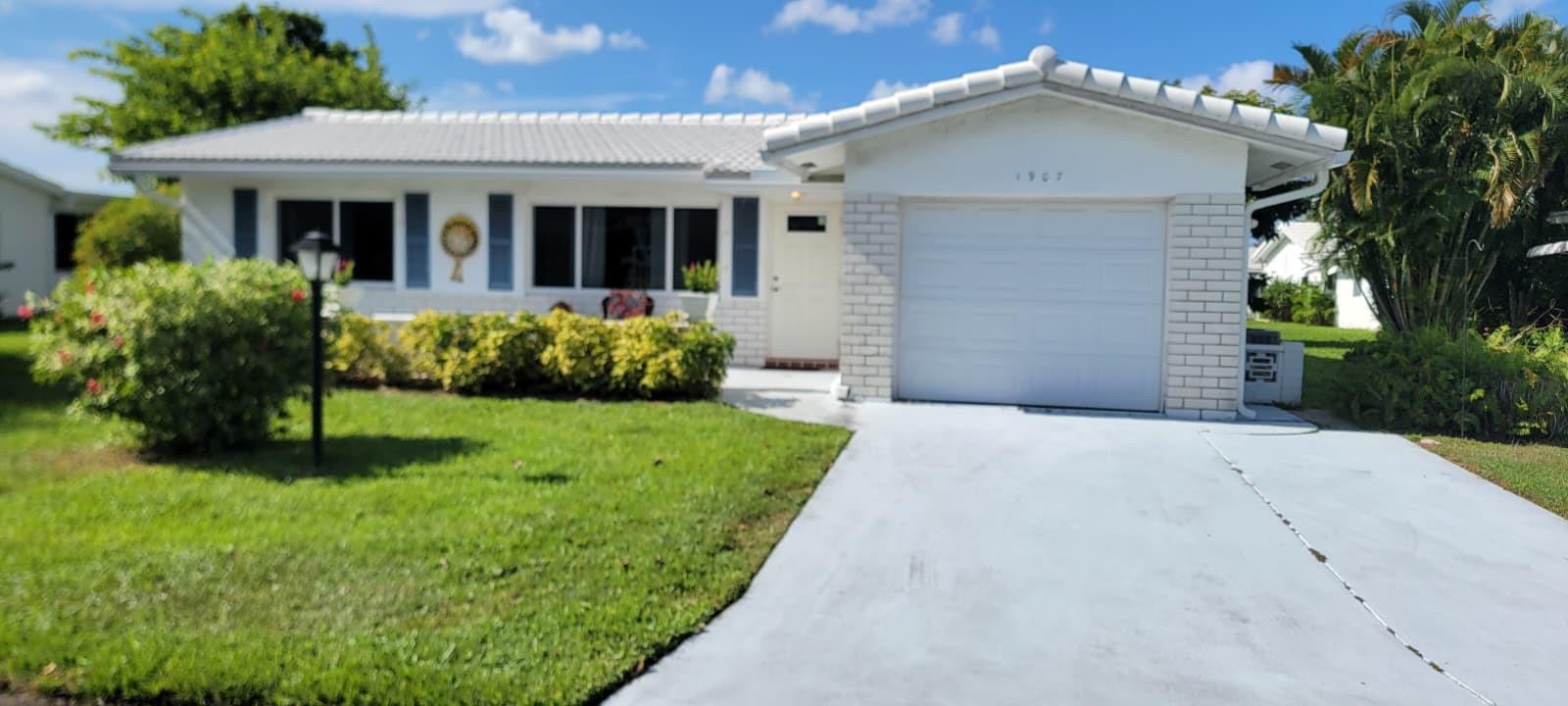 Discover refined living in Leisureville, Boynton Beach’s premier 55+ community. This beautifully updated home features a new roof (2023), impact windows, and stylish bathroom vanities, all surrounded by lush green space for added privacy. Leisureville offers resort-style amenities including a vibrant clubhouse, two heated pools, tennis, bocce, shuffleboard, scenic walking trails, and a meticulously maintained 18-hole golf course with practice greens. Ideally located near pristine beaches, fine dining, and shopping, this residence is more than a home—it’s a lifestyle of comfort, elegance, and ease.