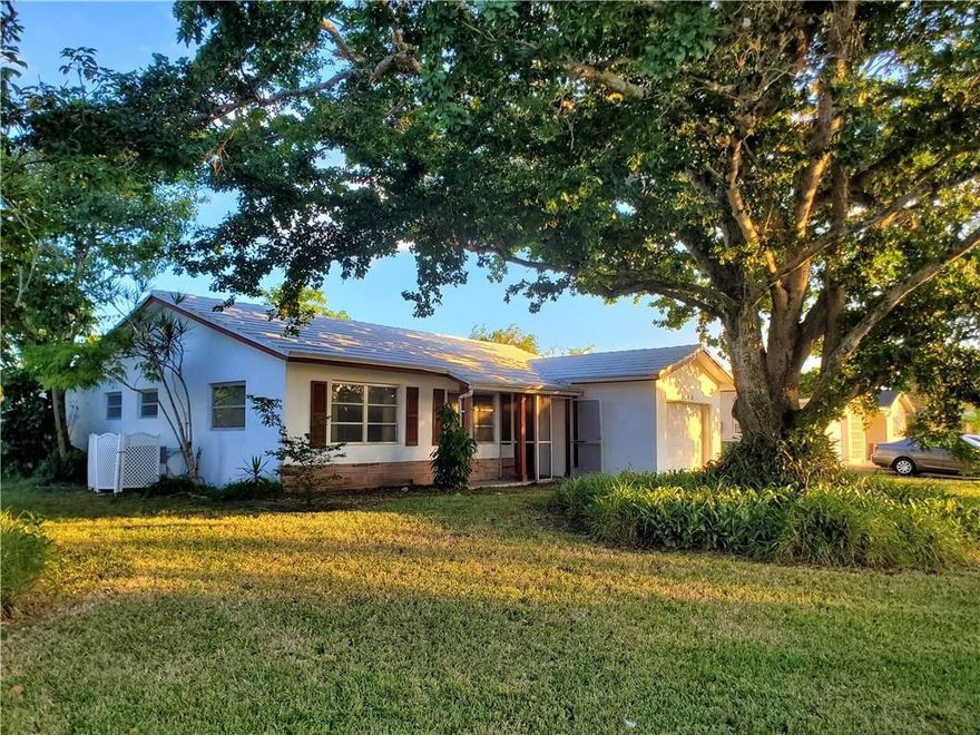 Cozy 2 bedroom home in Tamarac's 55+ Westwood community has just been refreshed and is waiting for new owners! New Gray carpeting and paint throughout, white bright kitchen cabinets, Laundry room and garage.  Large screened in patio. Home features large Florida room and living room areas and is situated on a big corner lot with huge shade tree. Neighborhood has lovely pool and clubhouse, quiet manicured streets for walking and meeting neighbors. Close to shopping, highways, hospitals and more.