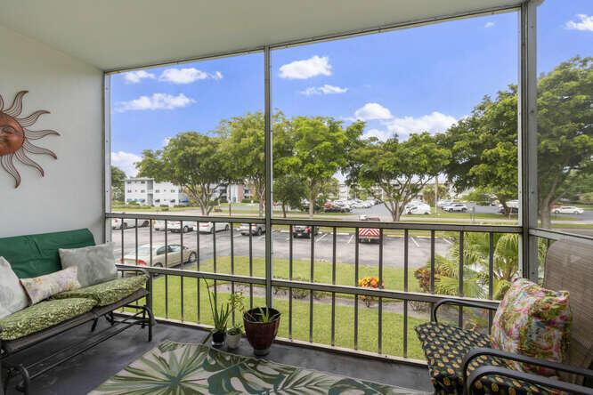 This updated 2-bedroom, 2-bathroom corner condo, located on the second floor of a 3-story building, offers a bright and inviting living space in the active 55+ Hillcrest No. 4 community. The unit boasts approximately 899 square feet of living area and features tile flooring throughout.Close to the Hard Rock Casino, parks, shopping, dining, and entertainment.The interior includes an updated kitchen with a tiled backsplash and white wood cabinets, along with updated bathrooms. Natural light fills the unit, enhancing its spacious feel. Residents can enjoy beautiful sunsets from their private, screened-in patio. This active adult community also has an amazing clubhouse with tons of amenities with scheduled events to keep anyone entertained.