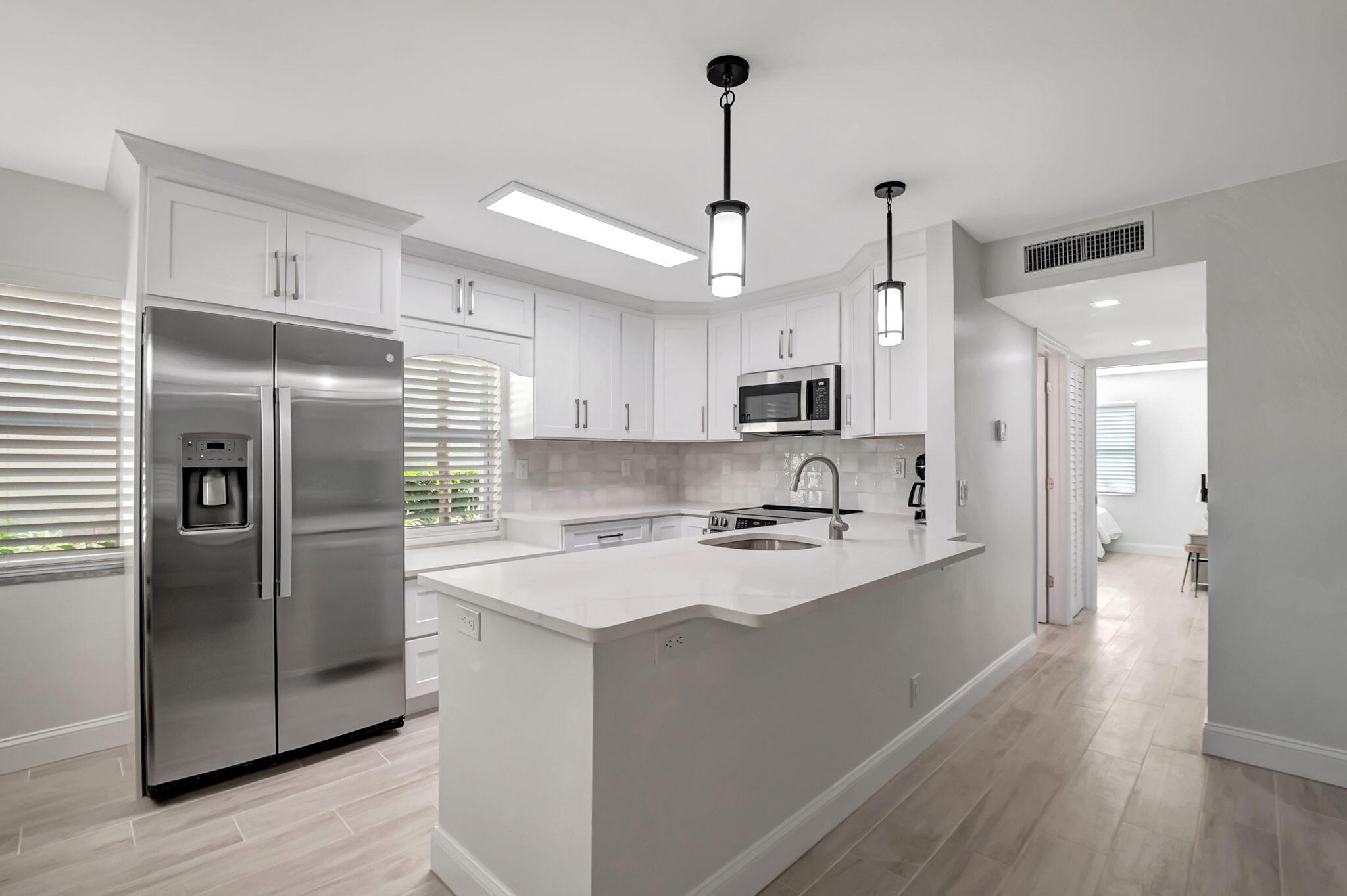 Step into luxury with this completely renovated 2-bed, 2-bath condo at 493 Flanders K, nestled in the vibrant 55+ community of Kings Point Golf and Country Club. RENT RIGHT AWAY NO WAIT! Every inch of this home has been thoughtfully upgraded with top-tier finishes, ensuring a seamless blend of elegance and functionality. This condo features all-new essentials, including a brand-new A/C system, hot water tank, and upgraded electric panel for worry-free living. The stunning open-concept kitchen is a chef's dream, boasting quartz countertops, top-of-the-line stainless steel appliances, a tiled backsplash, and ample natural light. A breakfast bar invites you to pull up a stool and enjoy your morning coffee in style. Freshly painted with smooth ceilings and designer wood-look porcelain tile