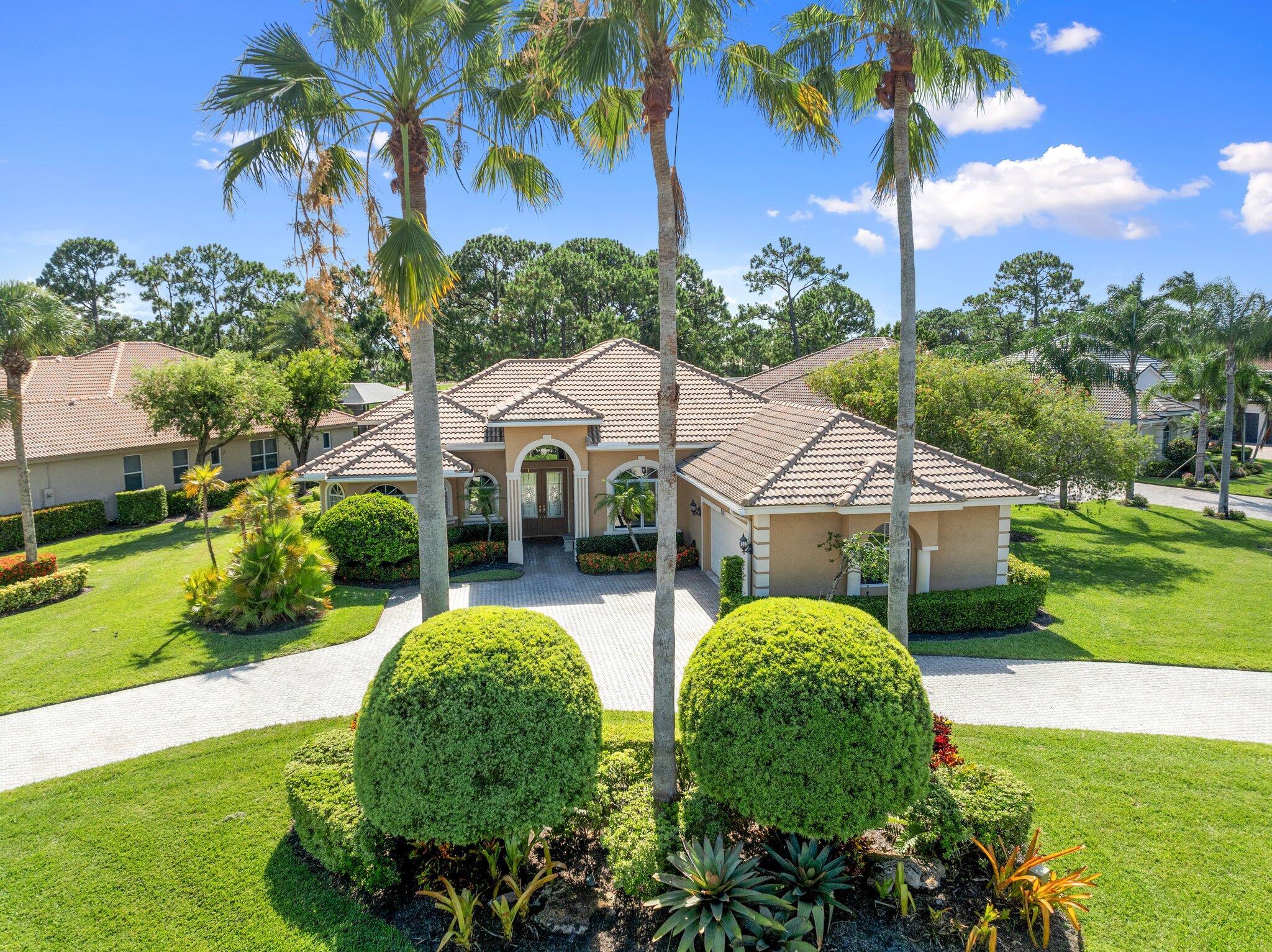Paradise Awaits at 8107 Links Way - nestled on the 17th Fairway of the Ryder Course in the exclusive Cypress Point neighborhood of PGA Village in Port St. Lucie. This updated 3 Bed + Den, 2.5 Bath, CBS Pool Home is Situated on an oversized corner lot with a unique circle driveway offering plenty of off-street parking. The home features intricately appointed high, coffered ceilings with crown molding, large windows and sliding doors offering natural light to your open floorplan, while providing views of the beautiful pool with waterfalls and the Ryder Course. The gourmet kitchen features NEW Quartz counters, marble backsplash, Kitchen Aid Stainless appliances, a walk-in pantry, and 42'' Solid Wood Cabinets.