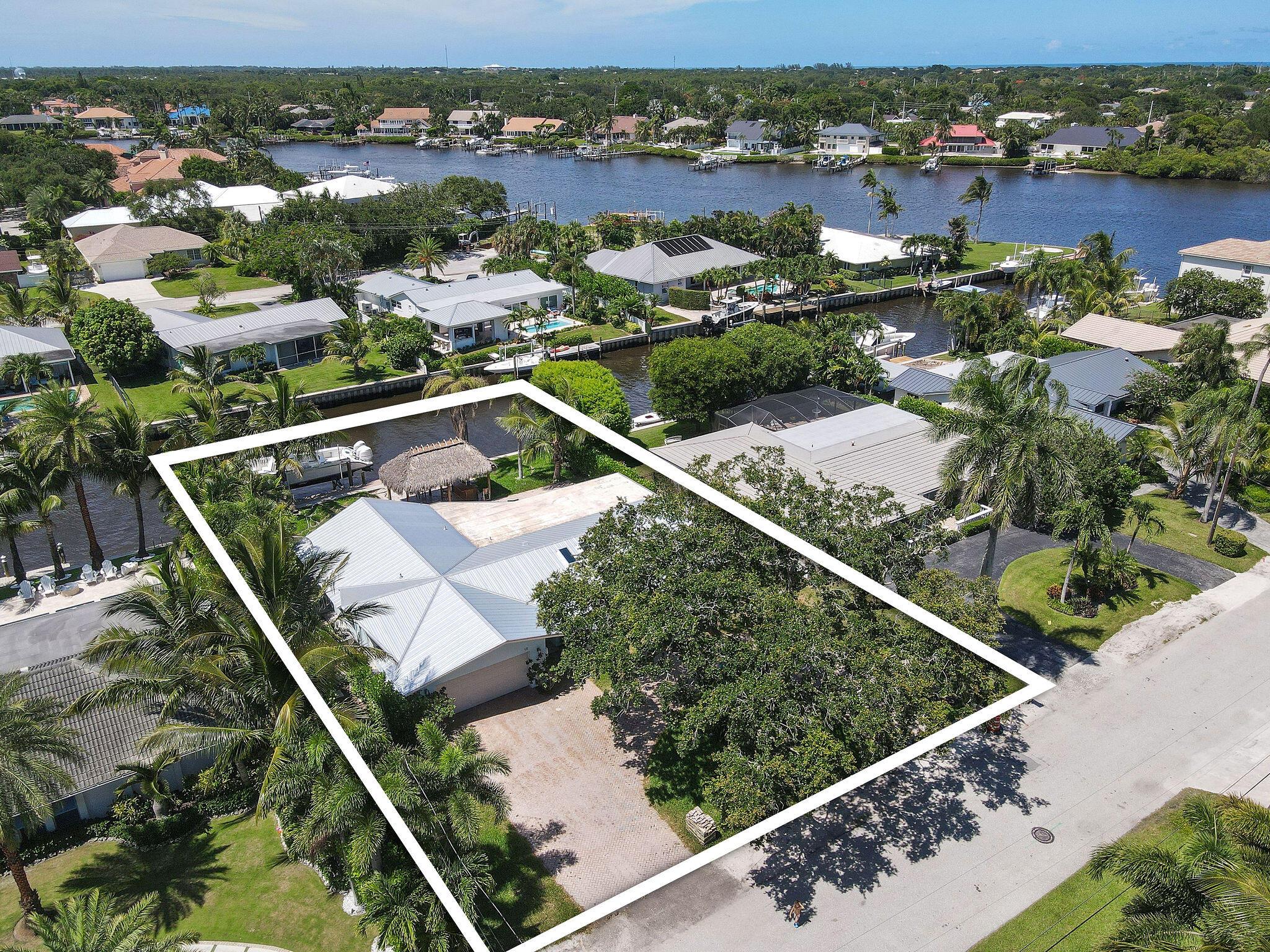 Nestled in the exclusive enclave of Country Club Point in Tequesta, this waterfront home presents an unparalleled opportunity for customization and luxury living. Inside, the home's interior is a blank canvas awaiting personalization. With the structure fully gutted and under construction, the potential is limitless for creating a bespoke residence tailored to the new owner's preferences and lifestyle. Situated on a beautiful waterfront lot with 85 ft of waterfrontage, the home offers views of the serene waterways that characterize Tequesta. The property features a private dock, pool area, and tiki hut, perfect for relaxing under the Florida sun or entertaining guests. Enjoy proximity to world-class golf courses, fine dining establishments, and boutique shopping, ensuring a lifestyle